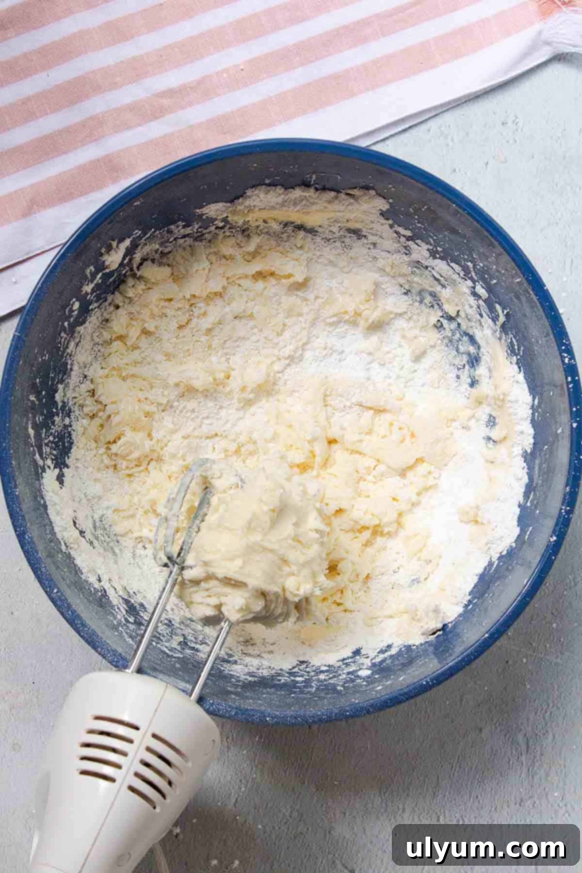 Cool Whip Cream Cheese Frosting 6 Powdered sugar is added slowly, a little bit at a time, to the cream cheese mixture and mixed in until fully incorporated.