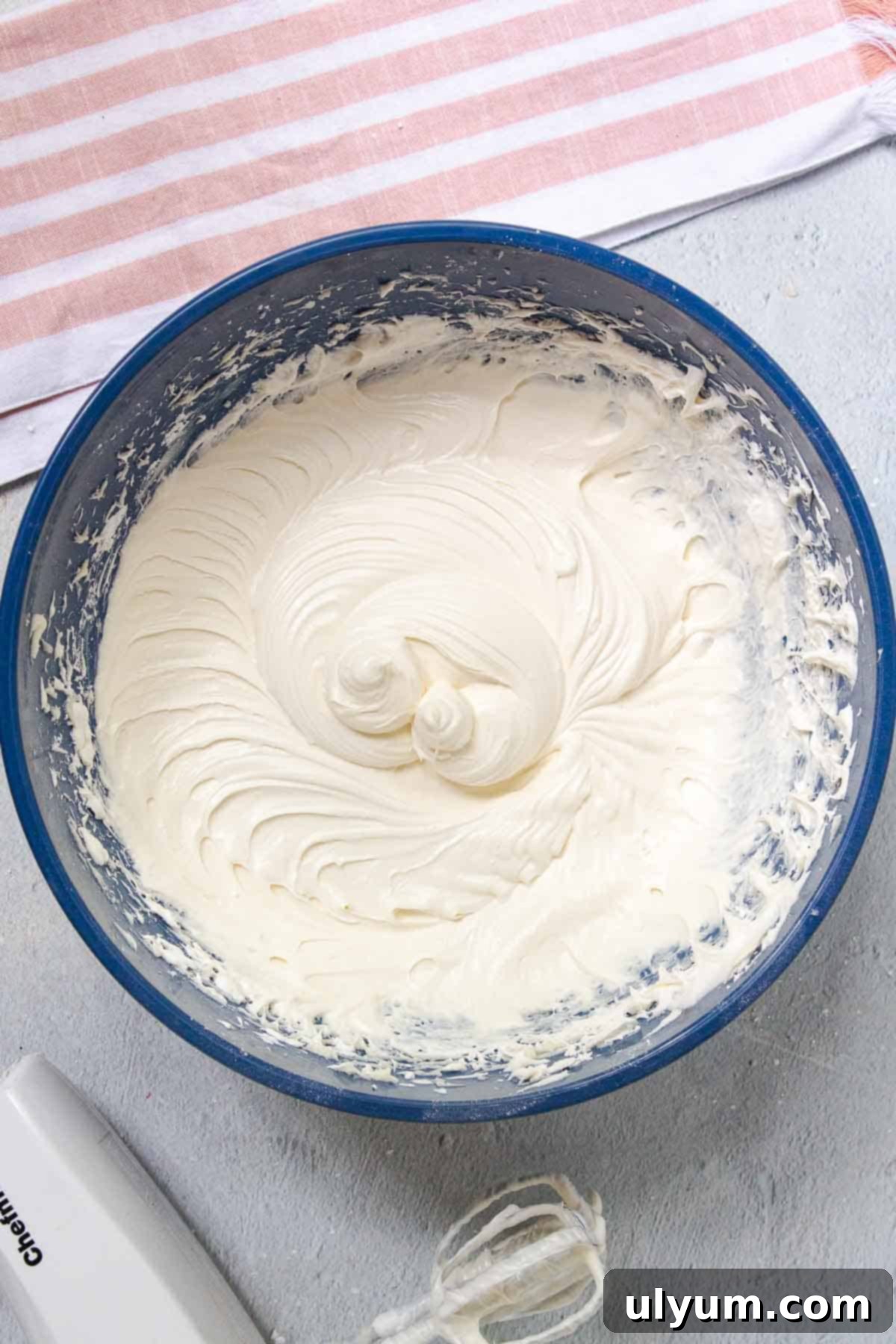 Cool Whip Cream Cheese Frosting 9 Finished Cool Whip Cream Cheese Frosting in a large mixing bowl, showing its light and fluffy consistency.