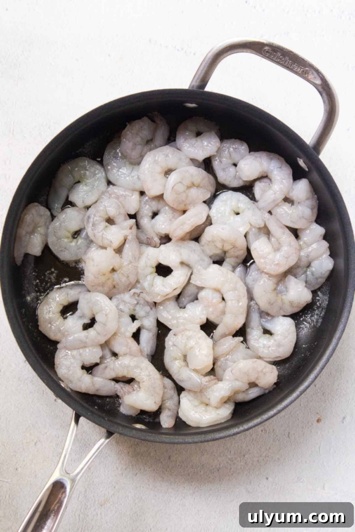 Uncooked peeled and deveined shrimp is added to the large skillet