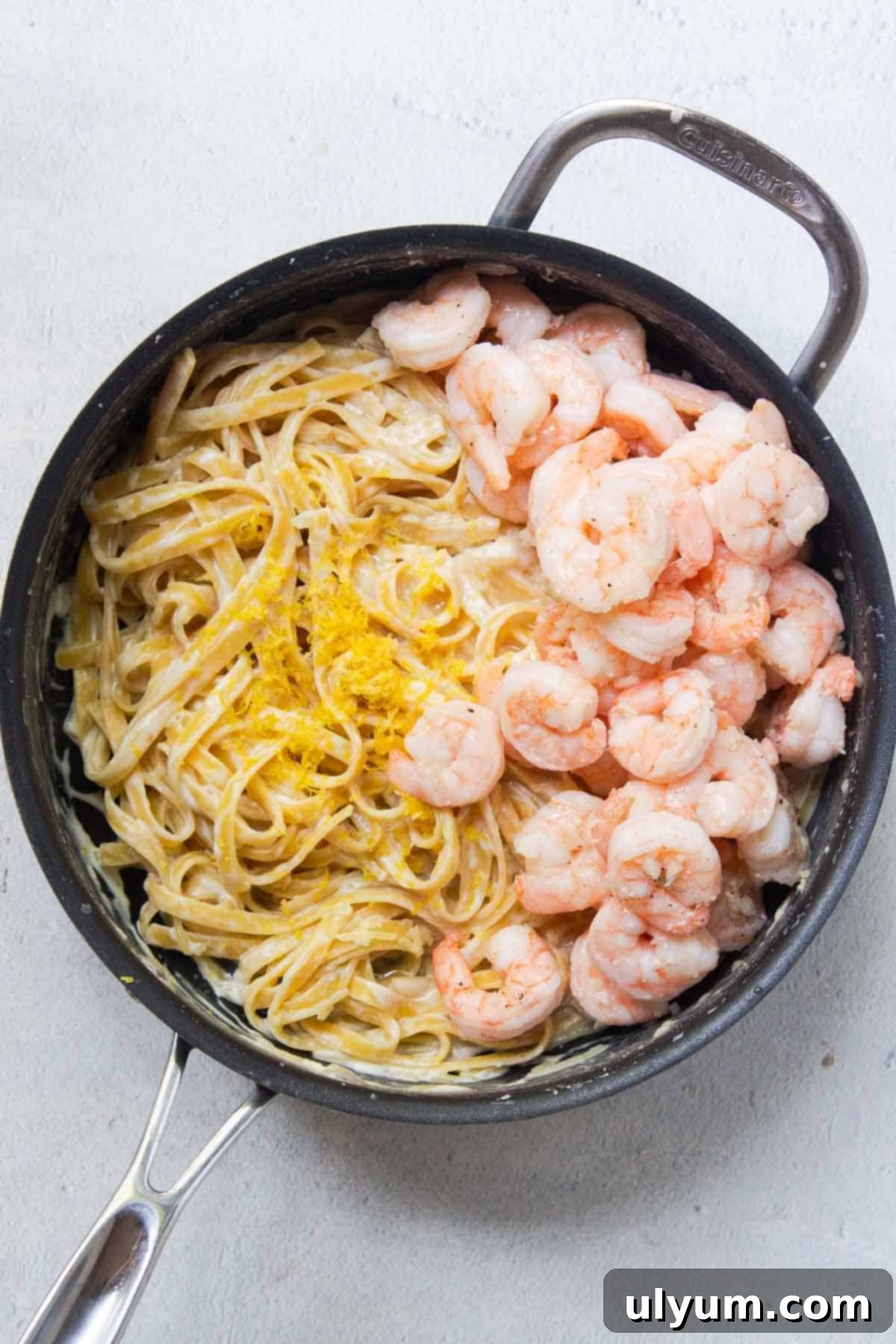 Cooked shrimp, parmesan, lemon juice, and lemon zest are added back to the cooked pasta