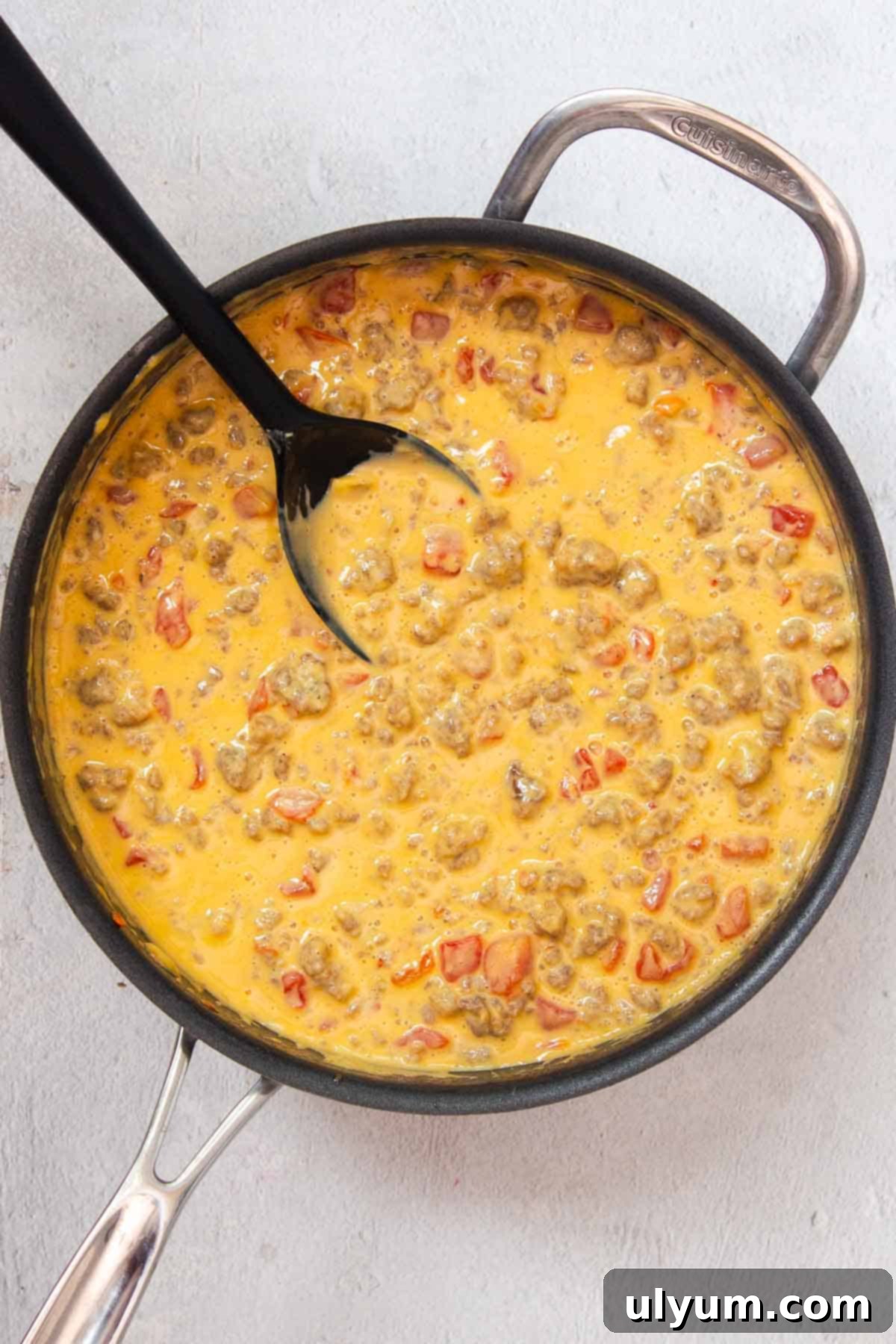 Ultimate Velveeta Sausage Dip 6 The Velveeta Sausage Cheese Dip, fully melted and combined, simmering gently in a large skillet, ready to be served.