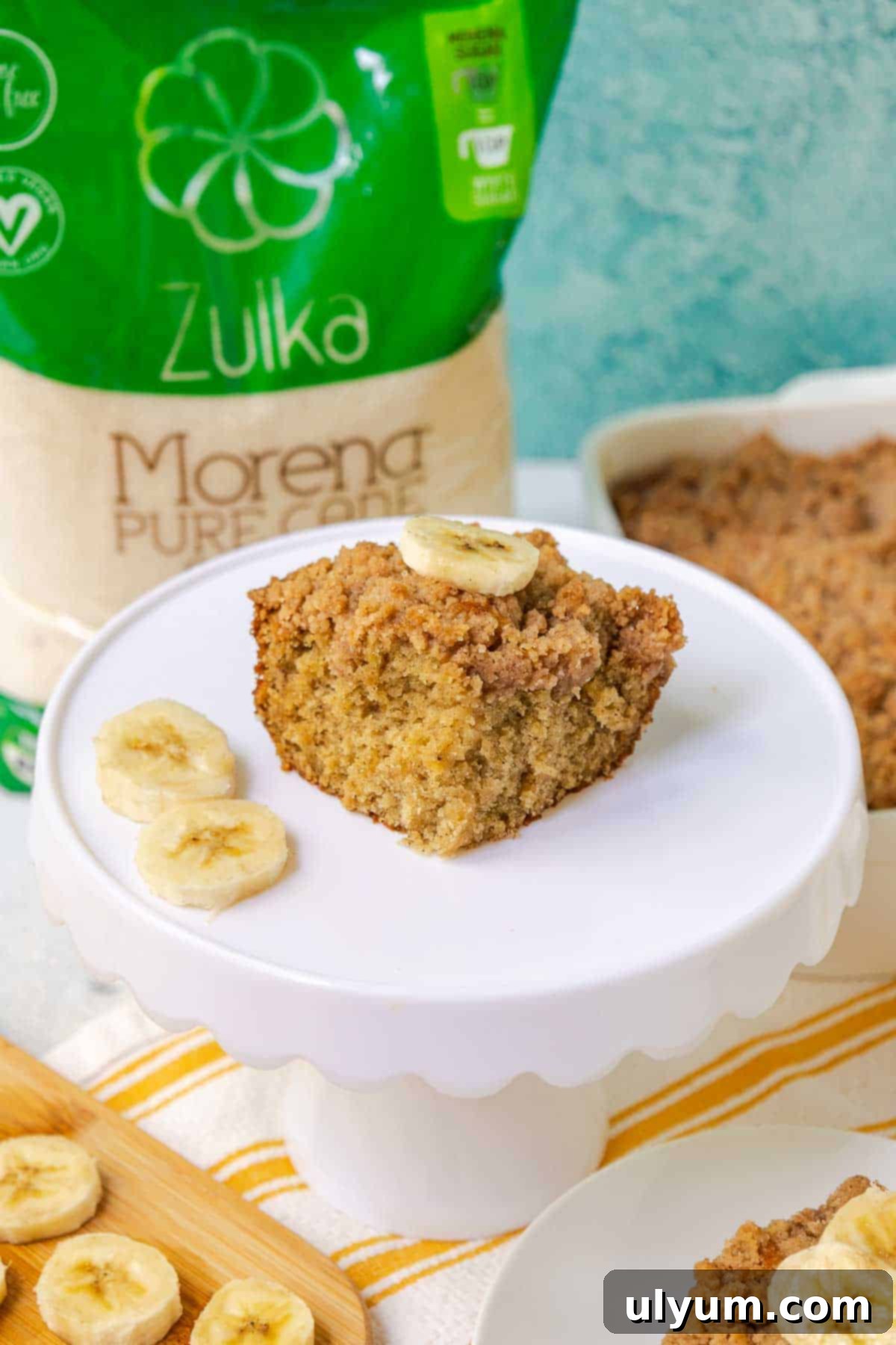 Banana Coffee Cake, a slice with a beautiful golden crumble topping and moist interior.