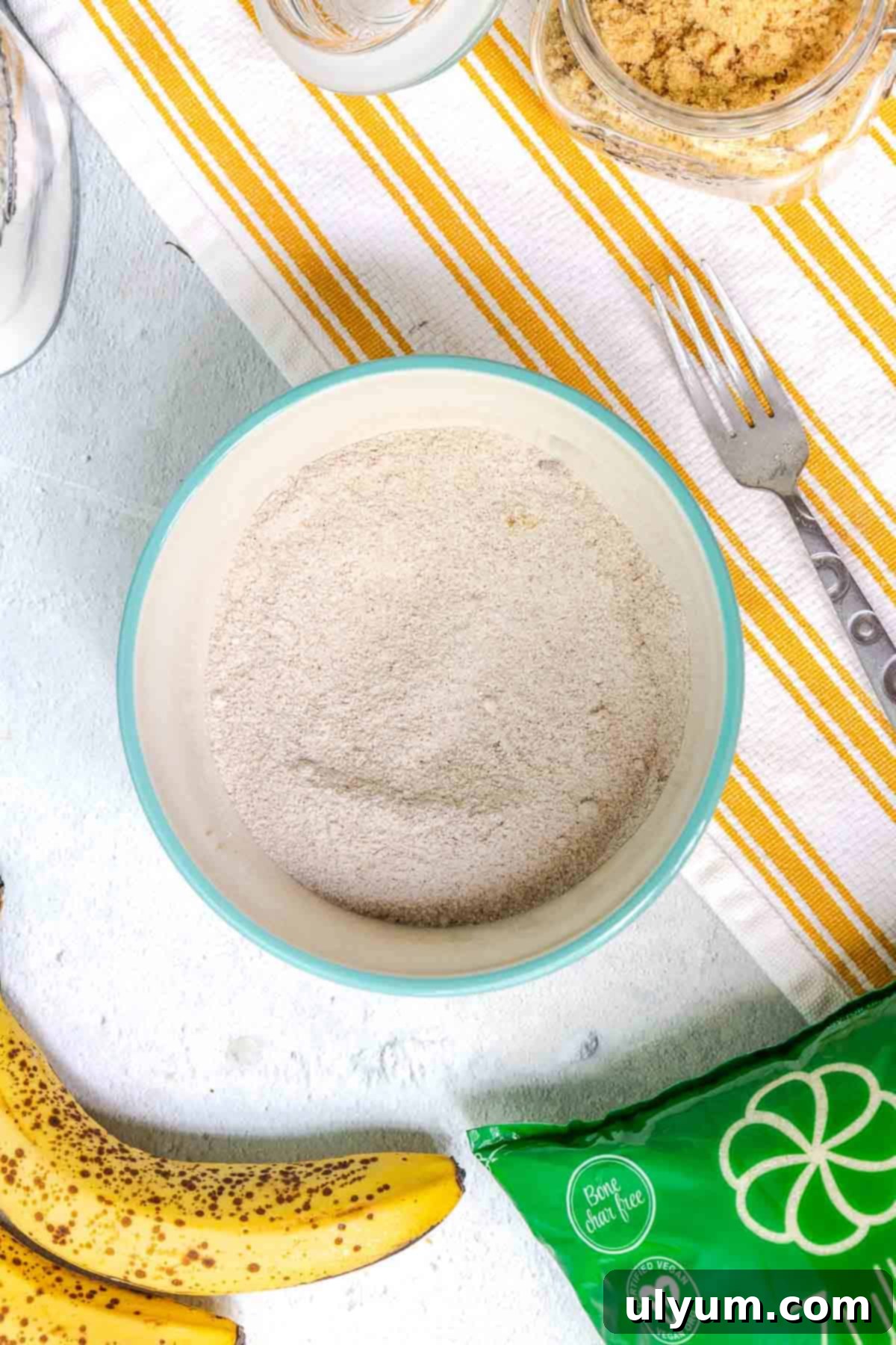 The dry ingredients for the crumble topping are mixed together in a small bowl, including flour, light brown sugar, granulated sugar, cinnamon, and salt.