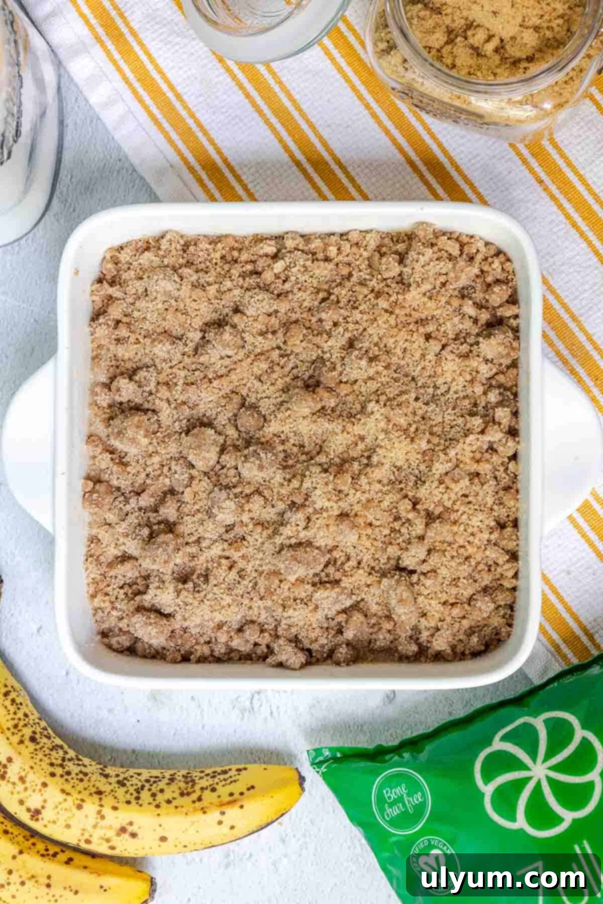 The banana coffee cake batter topped evenly with the cinnamon crumble mixture, ready for baking.