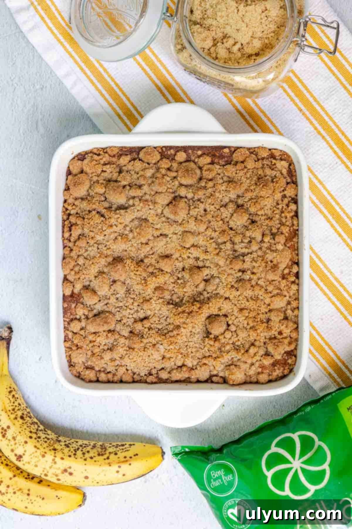 The baked banana coffee cake, golden brown and perfectly risen, showing a crisp crumble topping.