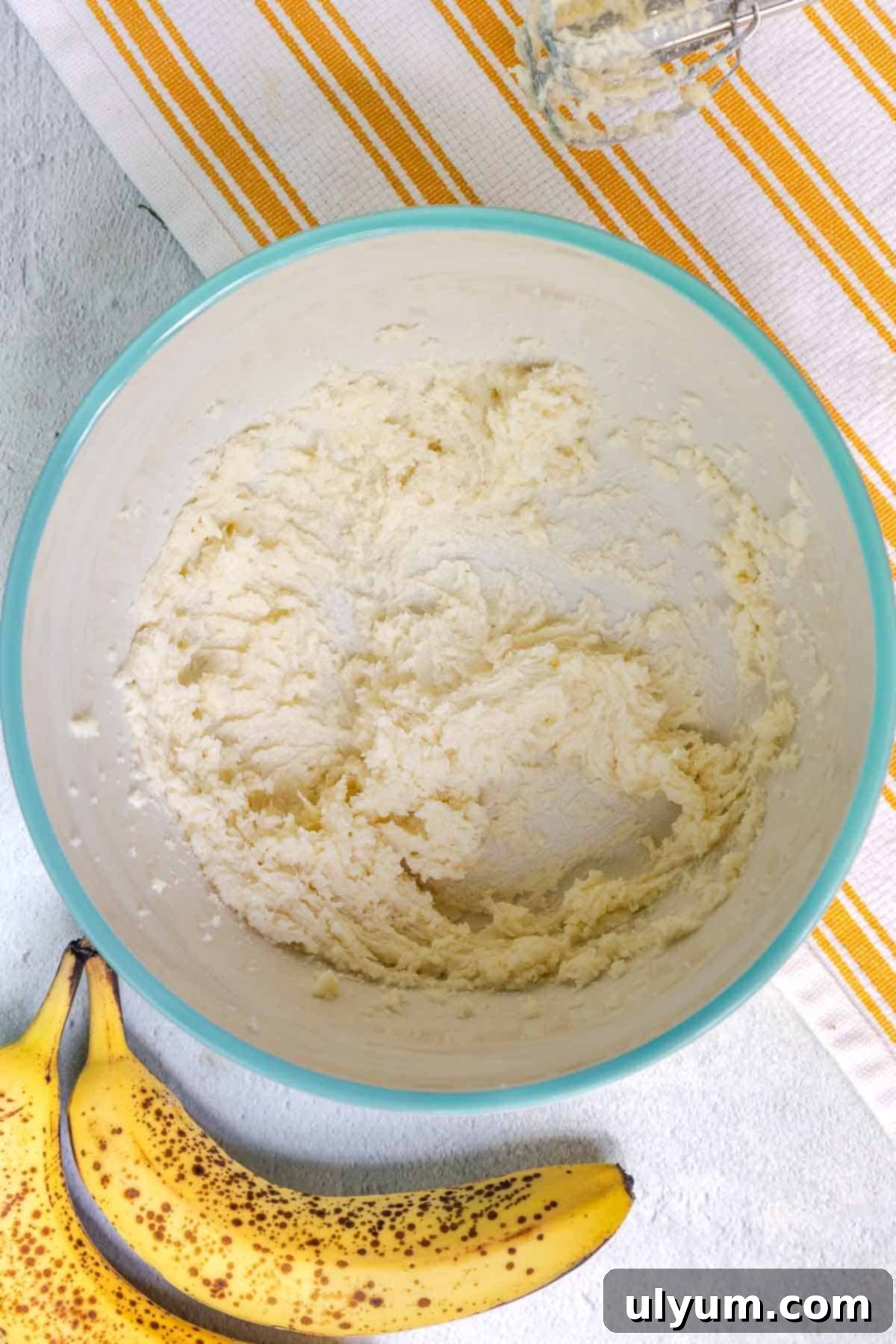 The butter and sugar have been creamed together in a bowl until light, airy, and fluffy, showing the proper consistency for the cake batter.