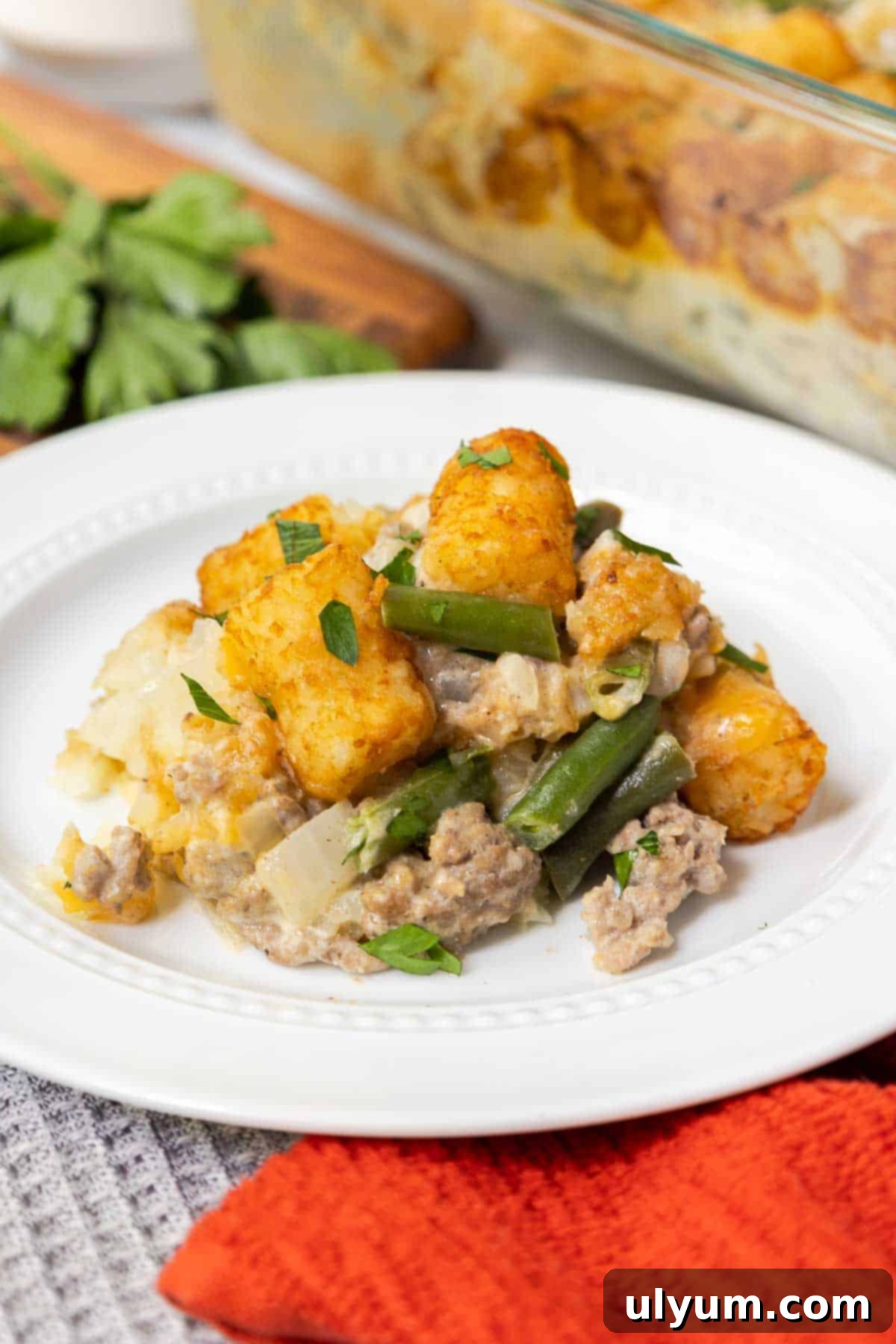Green bean tater tot casserole with cheese and ground beef, freshly baked and ready to serve.
