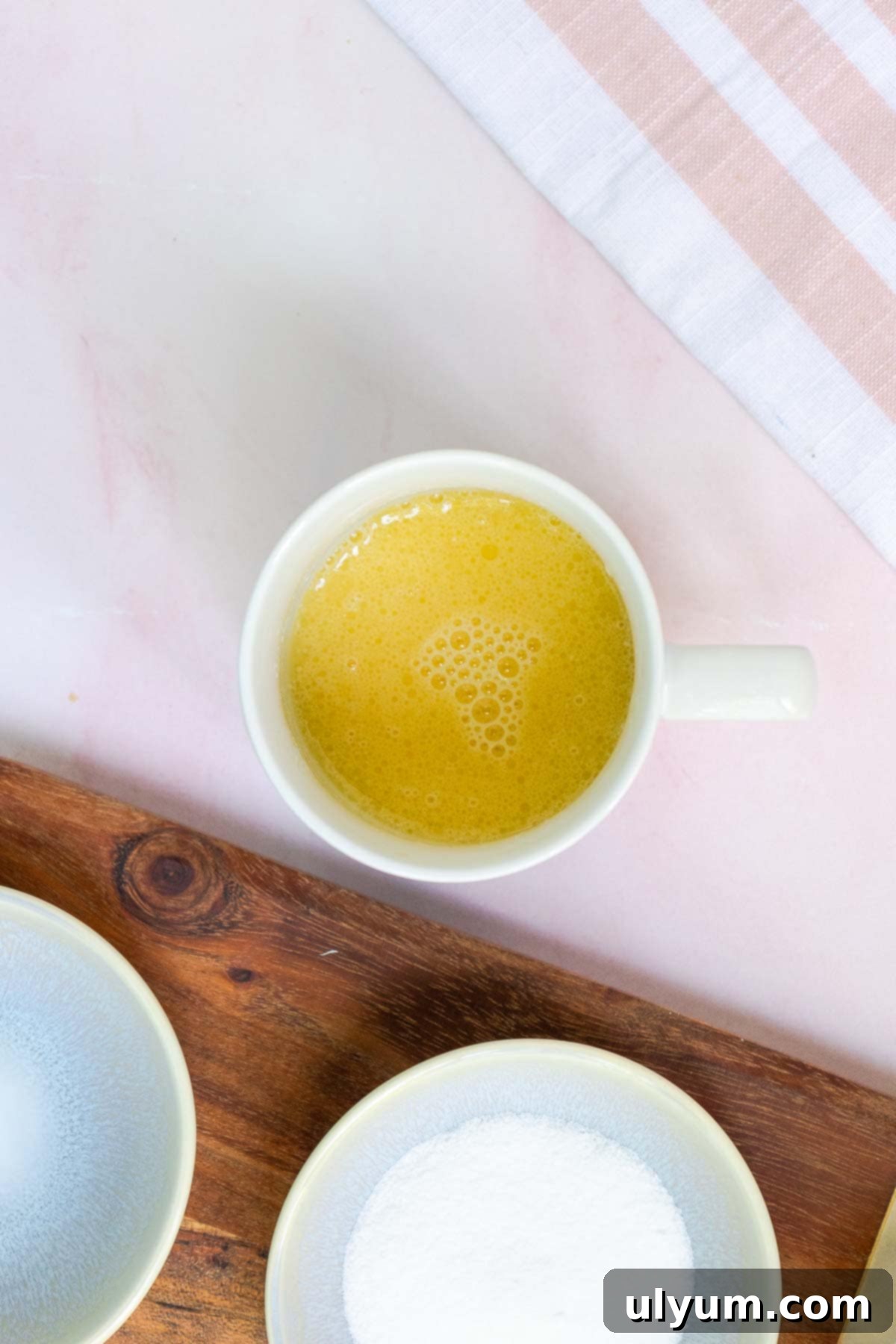 The egg yolk, milk, and vanilla extract are mixed into the melted butter until combined.