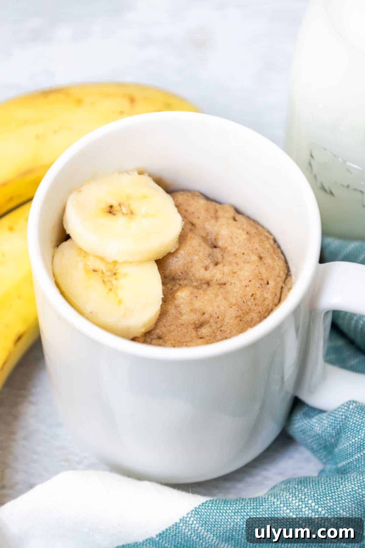 Banana Mug Cake topped with sliced bananas.