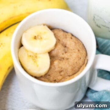 Banana Mug Cake topped with sliced bananas.