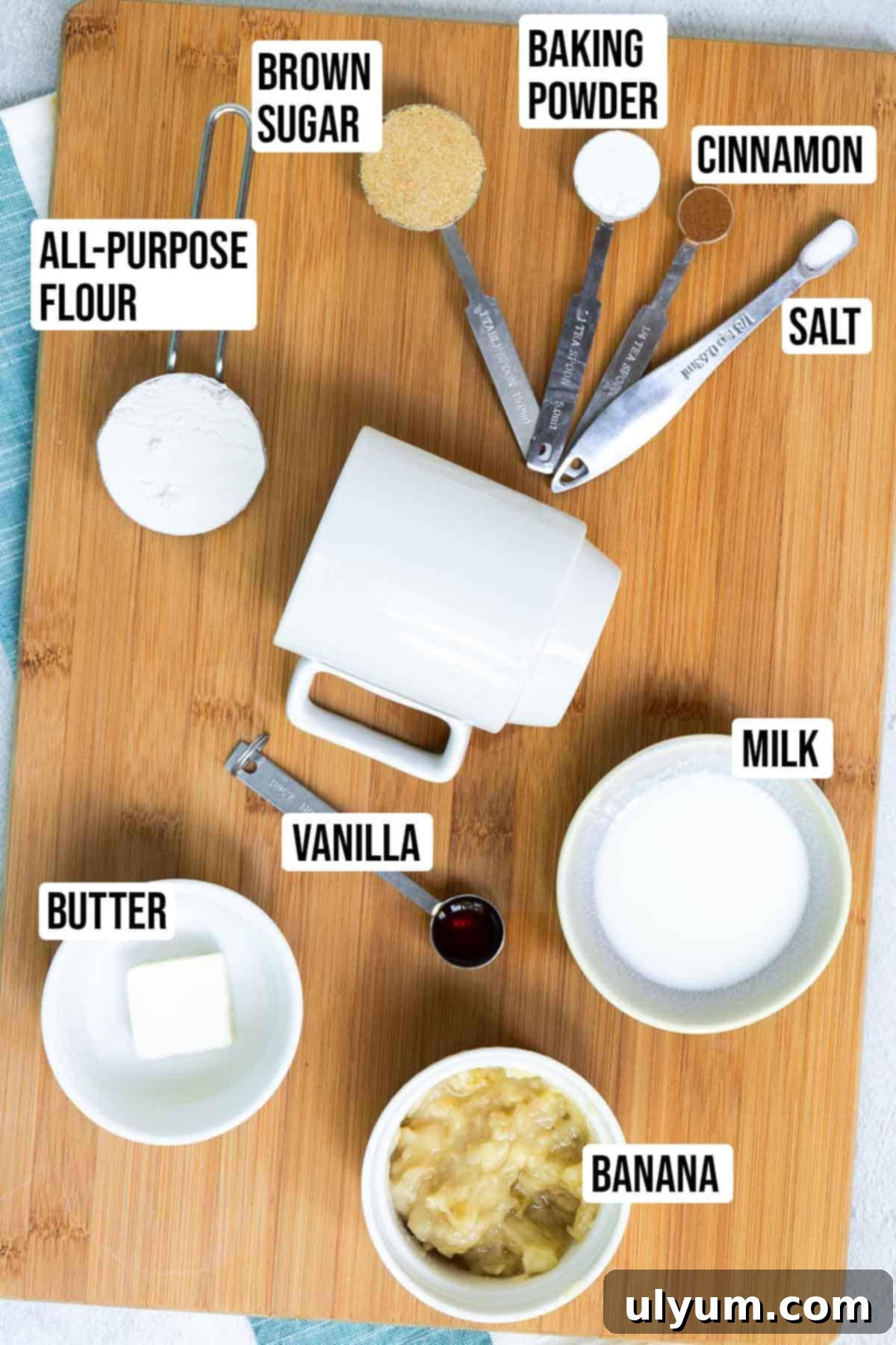 Banana mug cake ingredients: butter, mashed banana, milk, vanilla, flour, brown sugar, baking powder, cinnamon, salt.