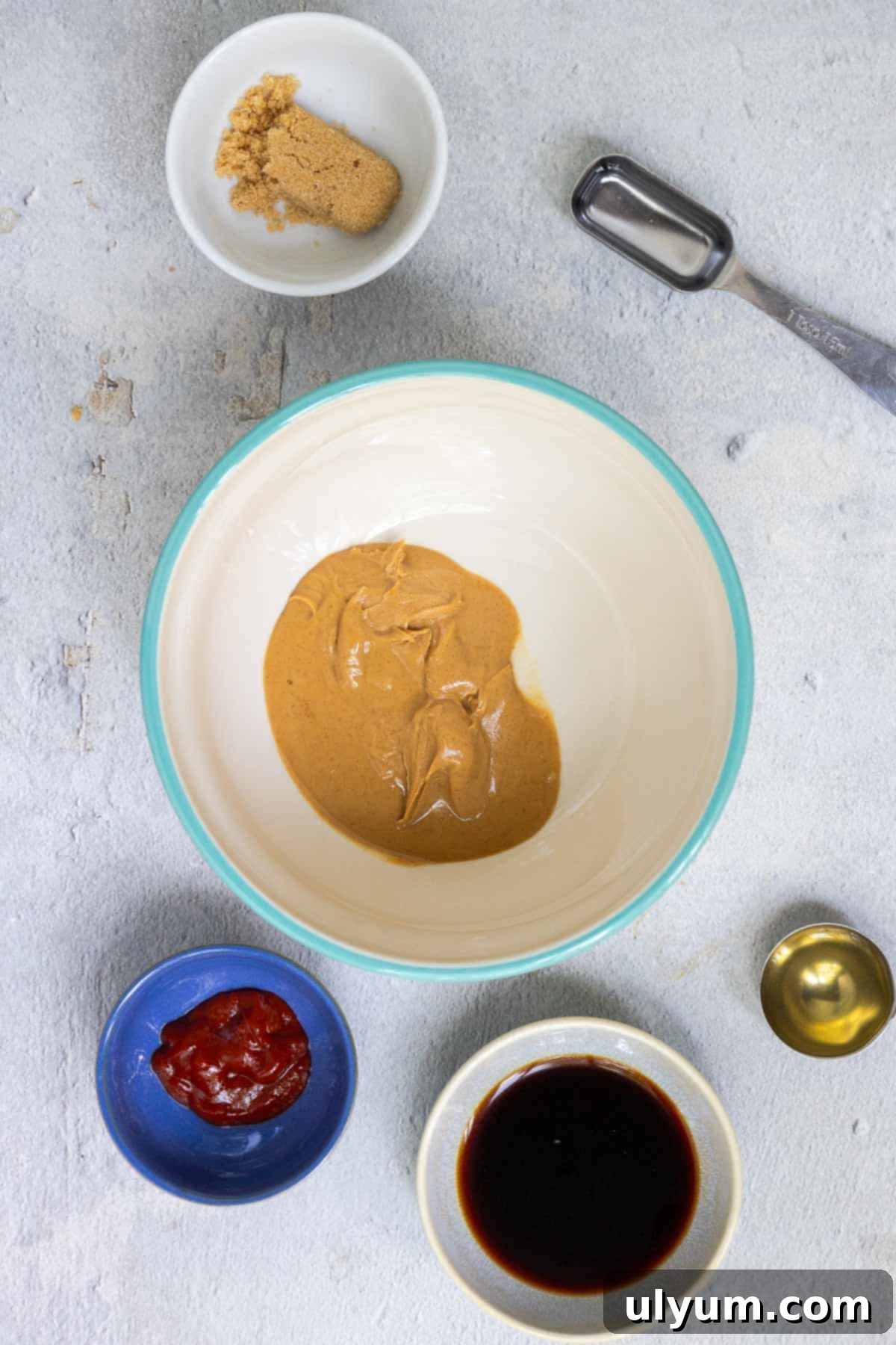 Creamy peanut butter is gently melted in a microwave-safe bowl, forming the base for the rich sauce.