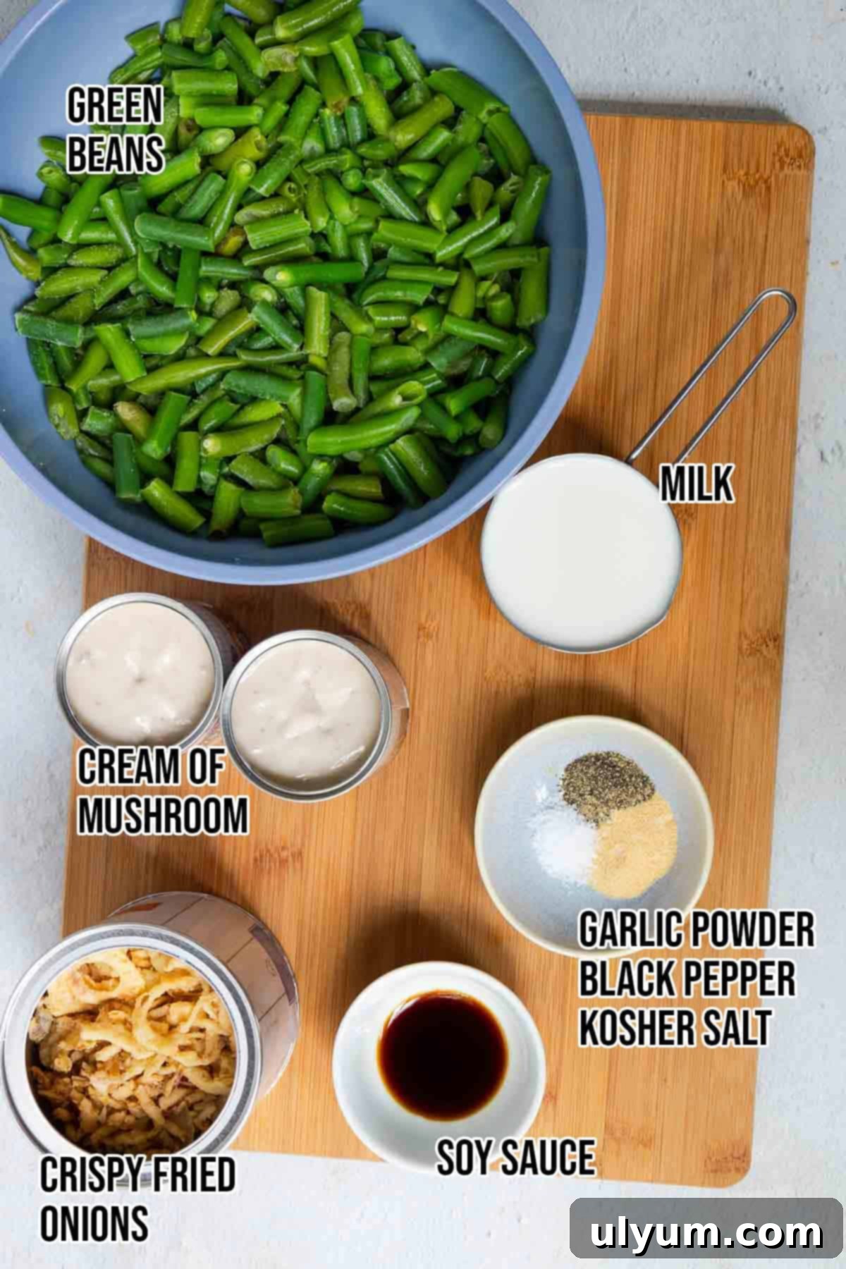 Holiday-Sized Green Bean Casserole 3 Green bean casserole ingredients: frozen green beans, crispy fried onions, cream of mushroom soup, milk, soy sauce, garlic powder, black pepper, and kosher salt.