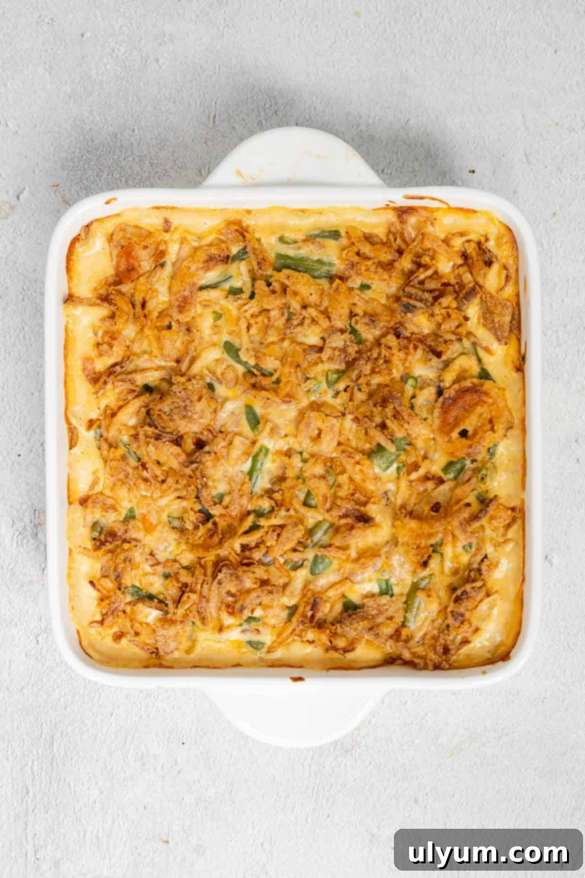 The crispy fried onions on top of the Velveeta green bean casserole are baked until golden brown and delicious.