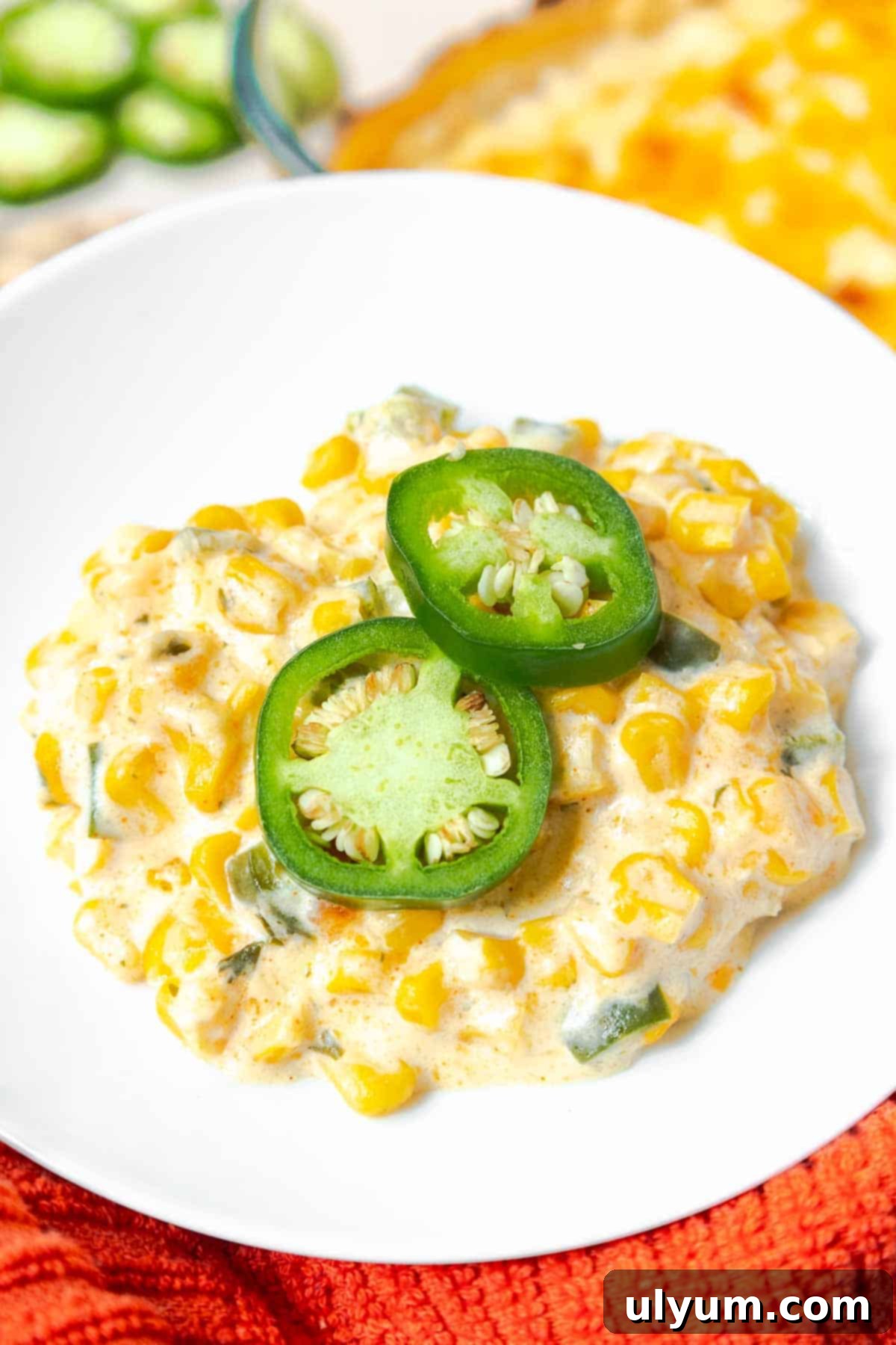 Creamy Jalapeño Corn Casserole garnished with fresh jalapeño slices.