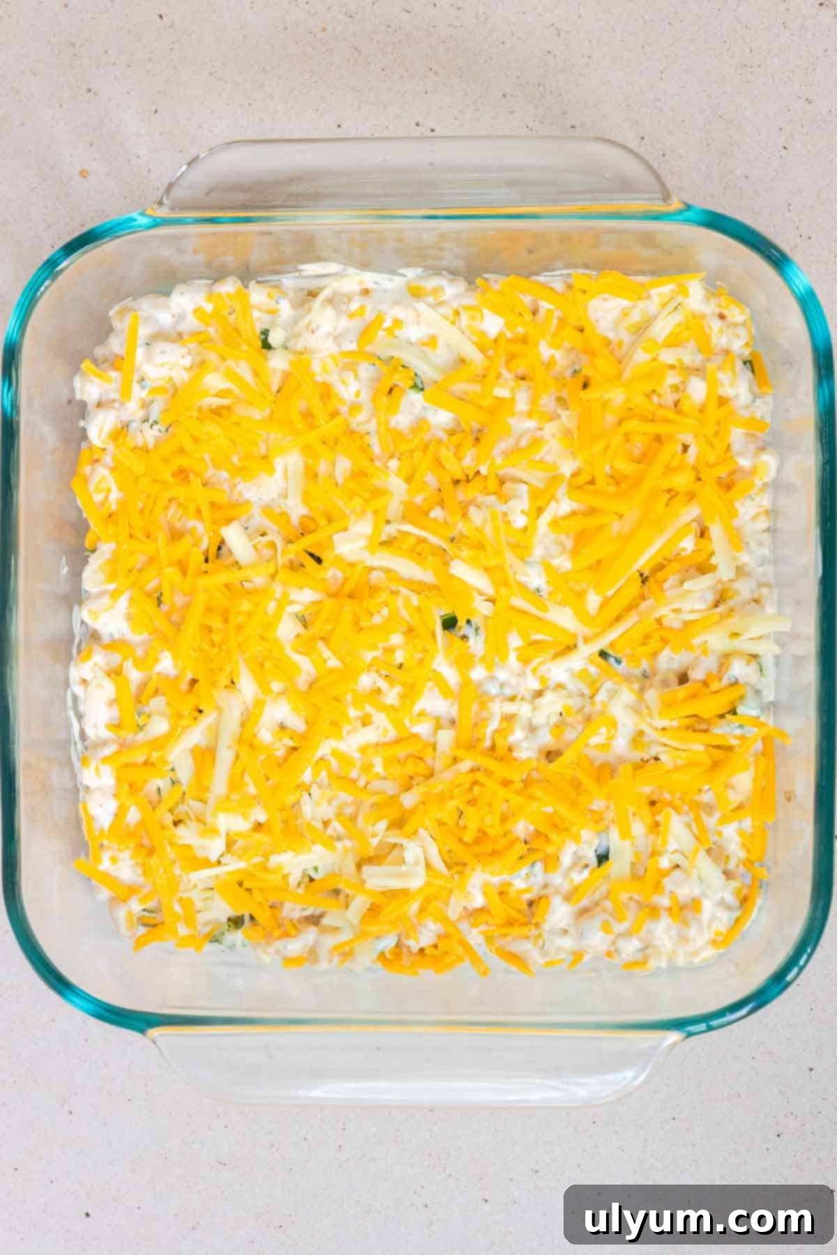 Shredded cheese is sprinkled evening over the top of the casserole.