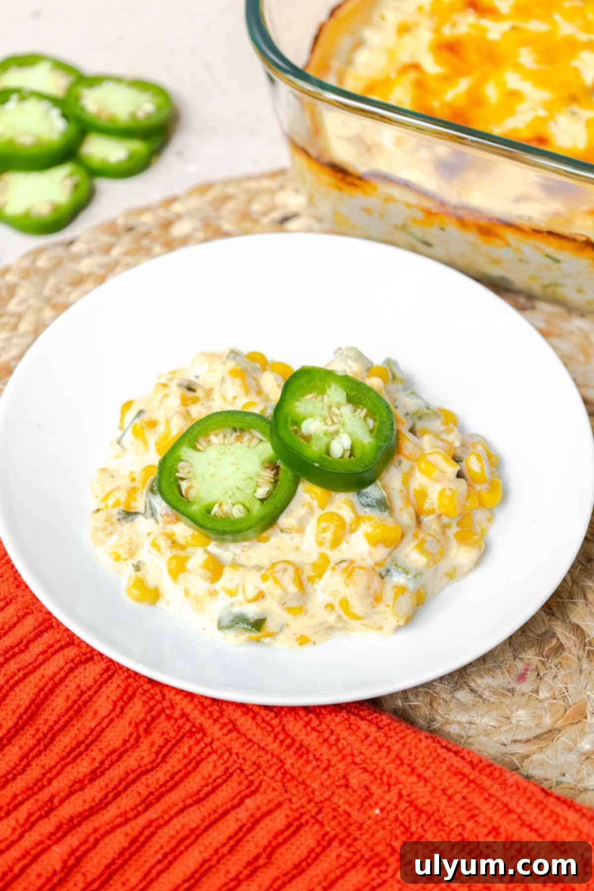 Creamy Jalapeño Corn Casserole garnished with fresh jalapeño slices