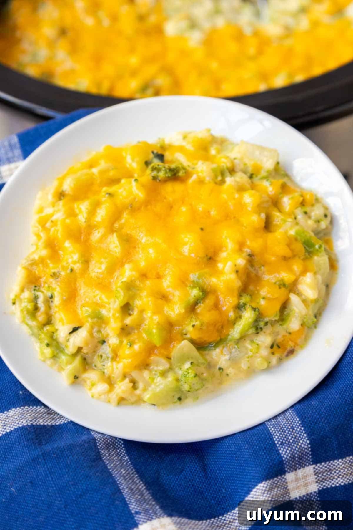 Crockpot Broccoli Rice Casserole topped with melted cheddar cheese, ready to serve.