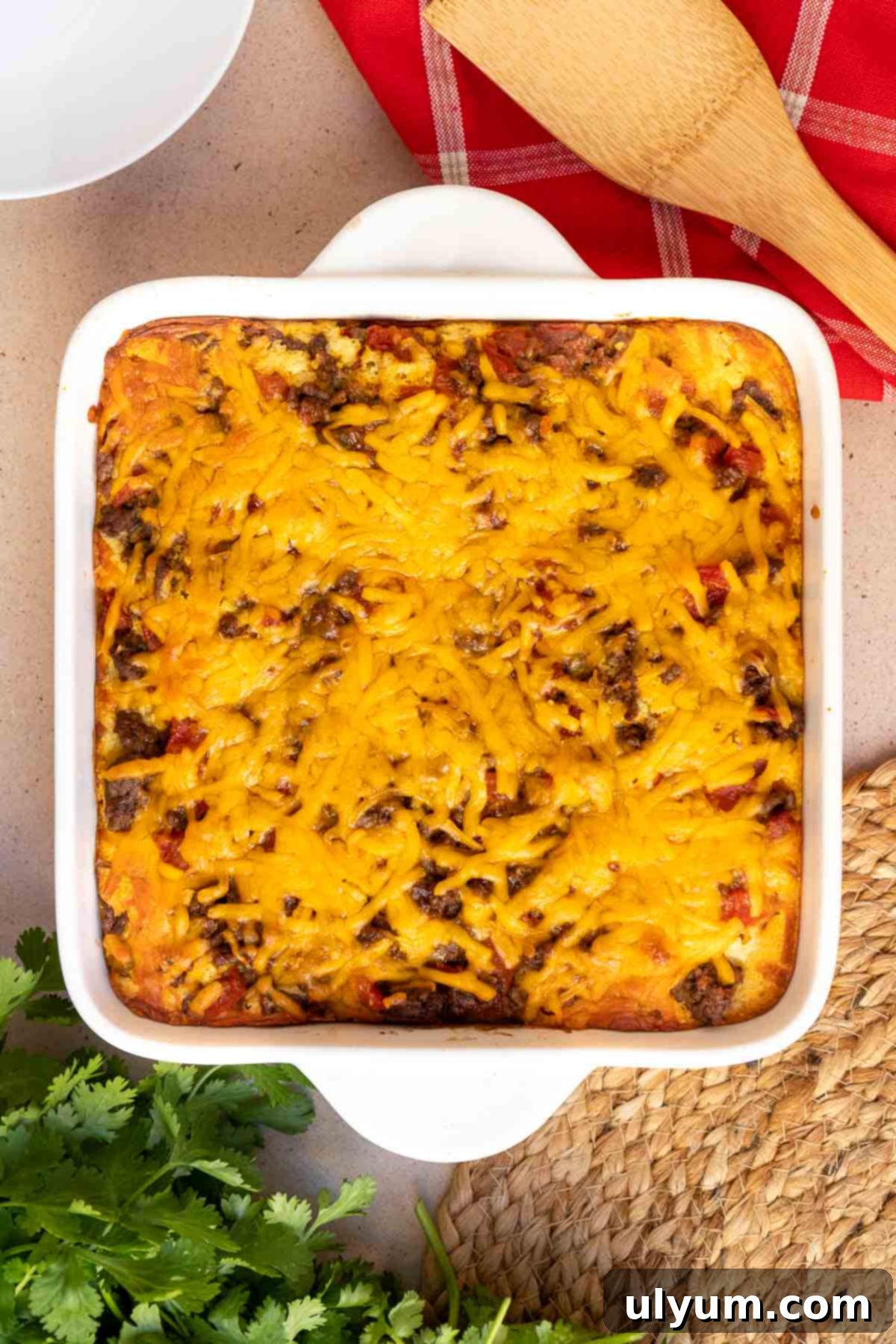 The Mexican cornbread casserole, freshly baked with a golden-brown cheesy top and perfectly cooked cornbread base, ready to be cooled.
