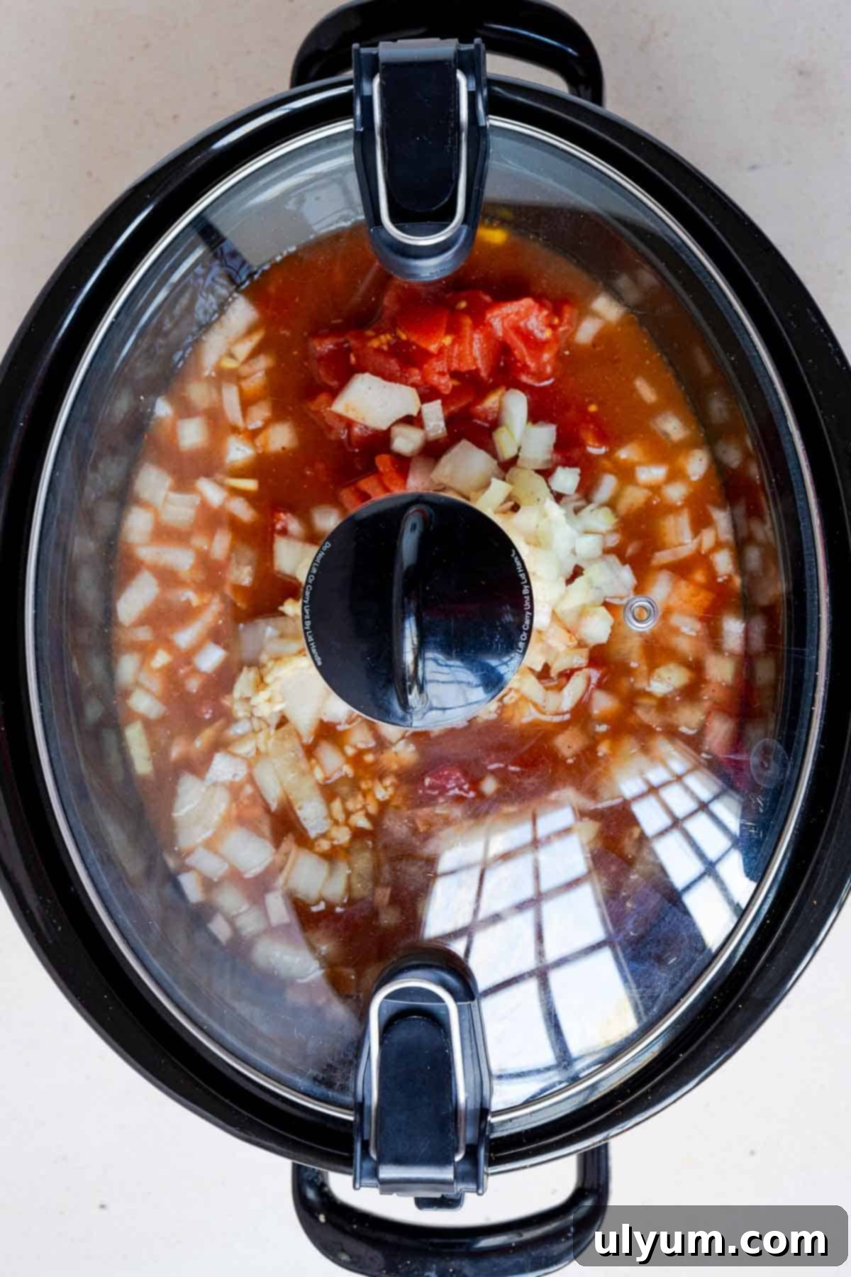 The lid is on the slow cooker while the chili cooks.