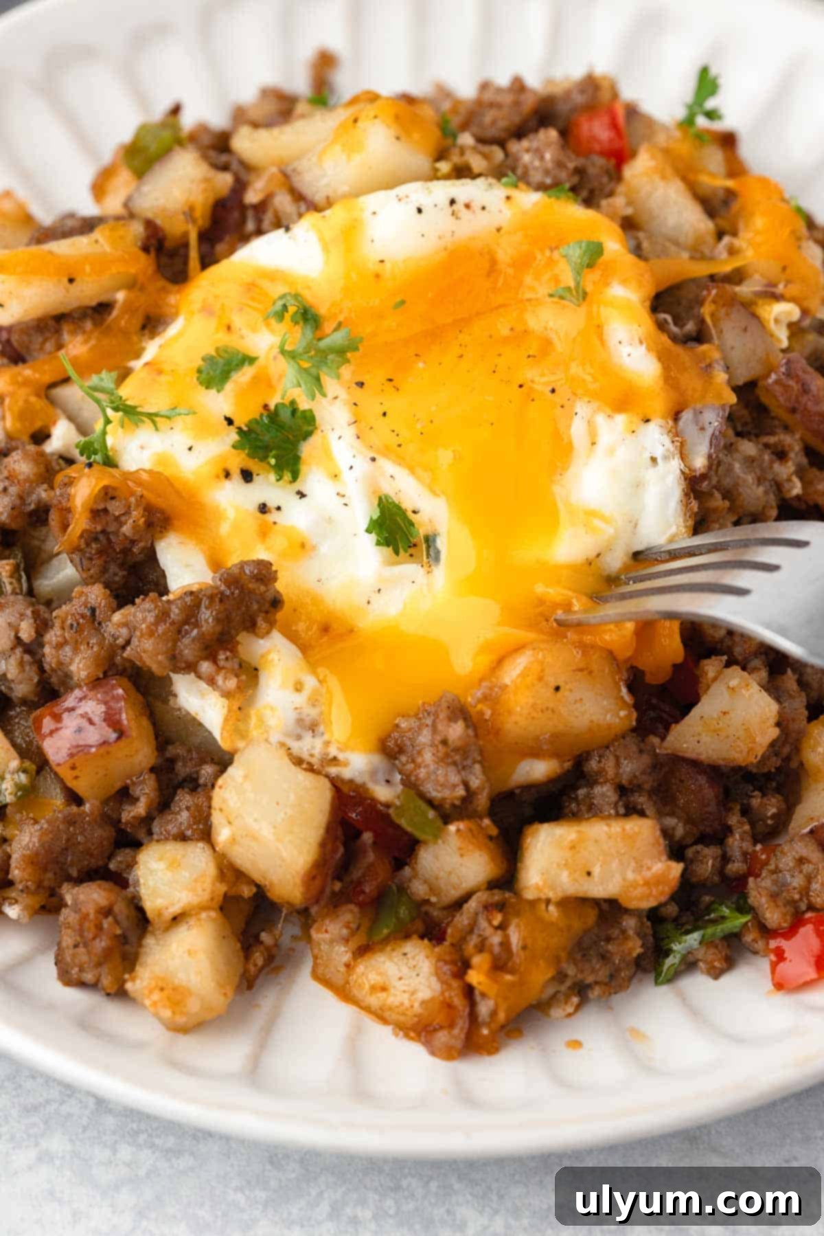 The breakfast sausage potato skillet is made with eggs cooked with a runny yolk.