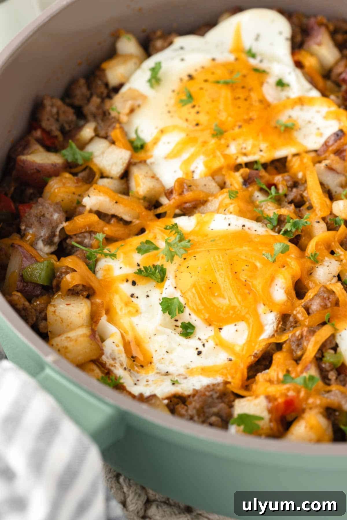 Breakfast sausage potato hash with eggs and cheese.
