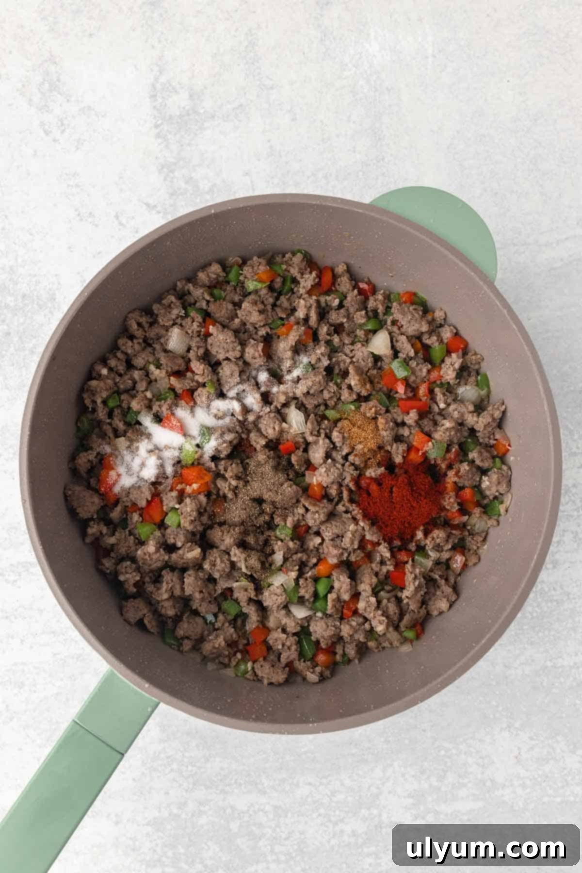 Once the veggies are cooked, seasoning is added to the skillet.