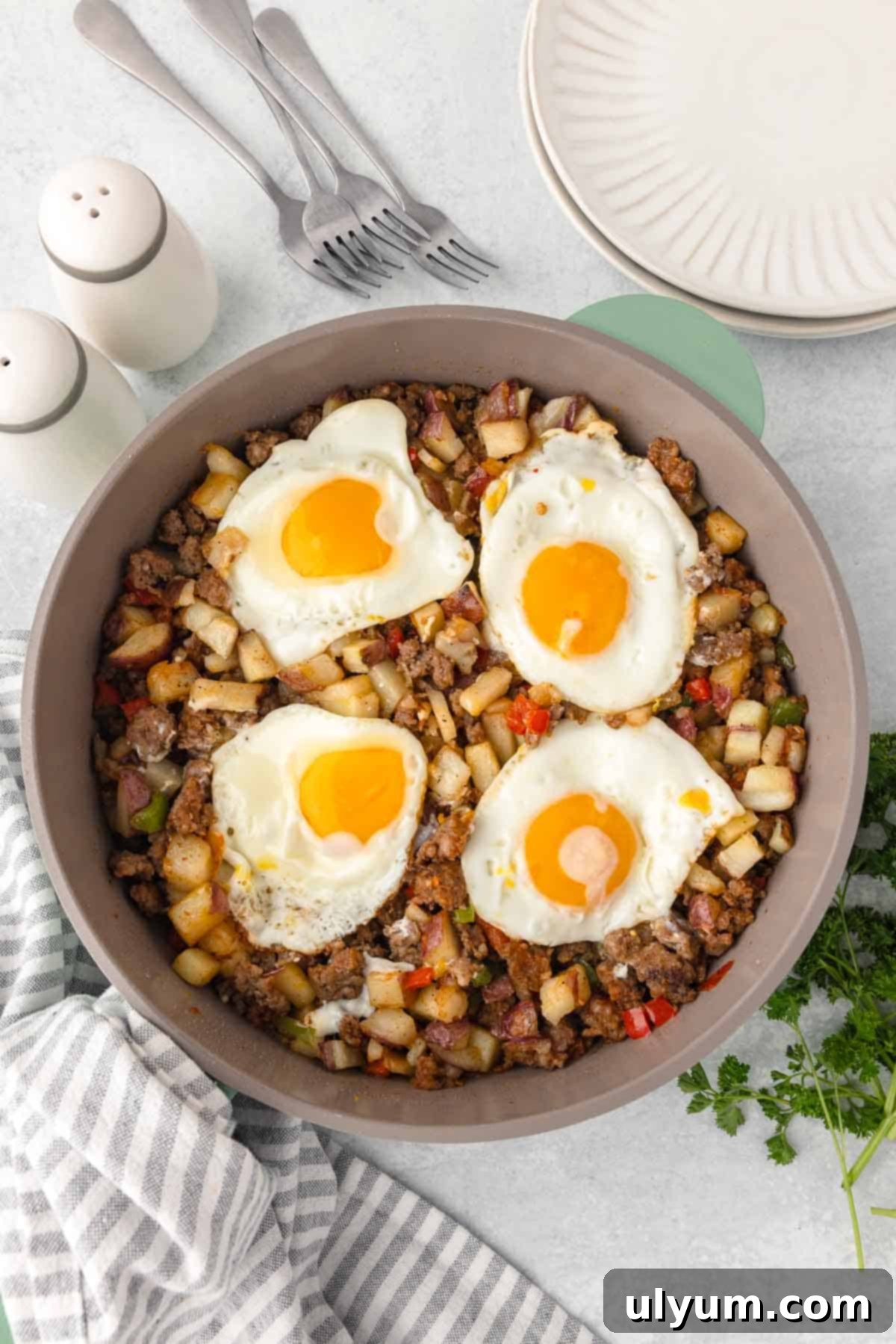 Breakfast skillet with eggs. The eggs are cooked with soft runny yolks.