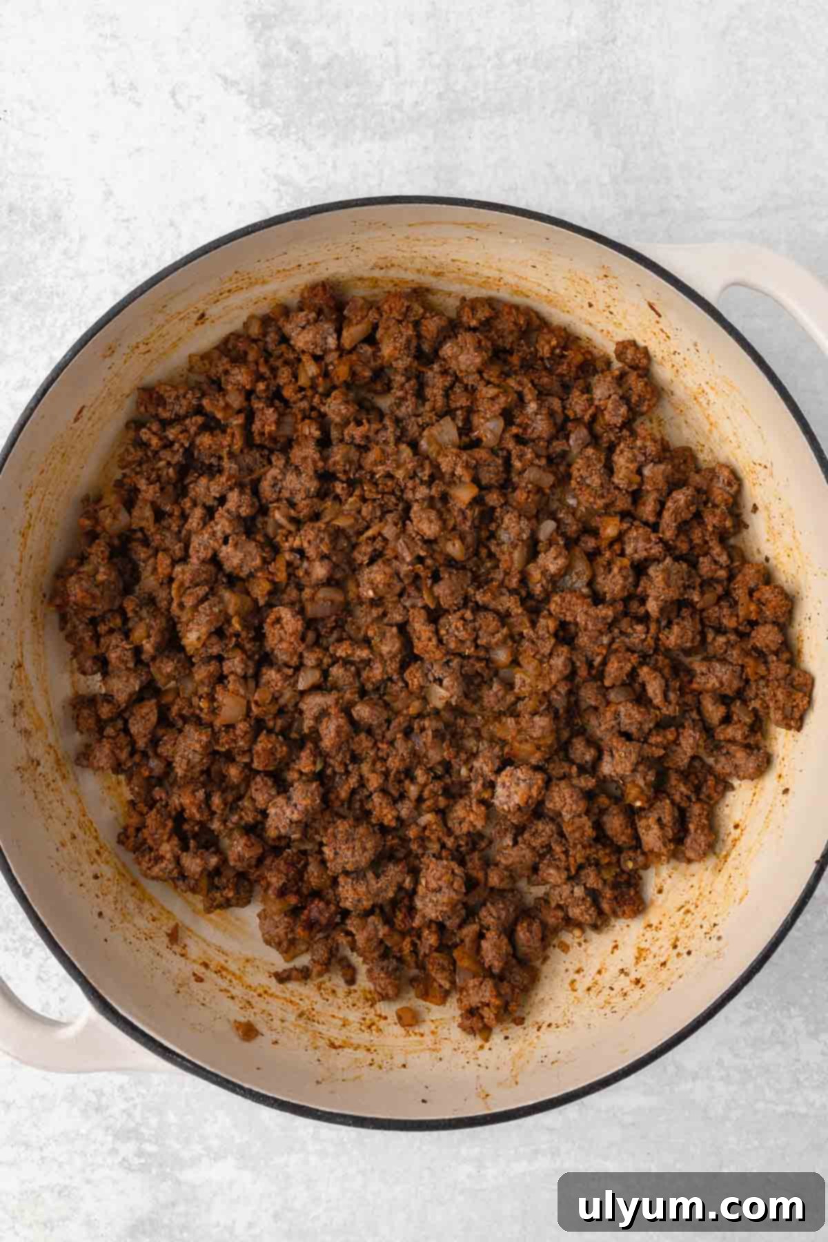 The Ultimate One-Pot Cheesy Taco Pasta 6 The seasoning blend is added to the ground beef and stirred together.