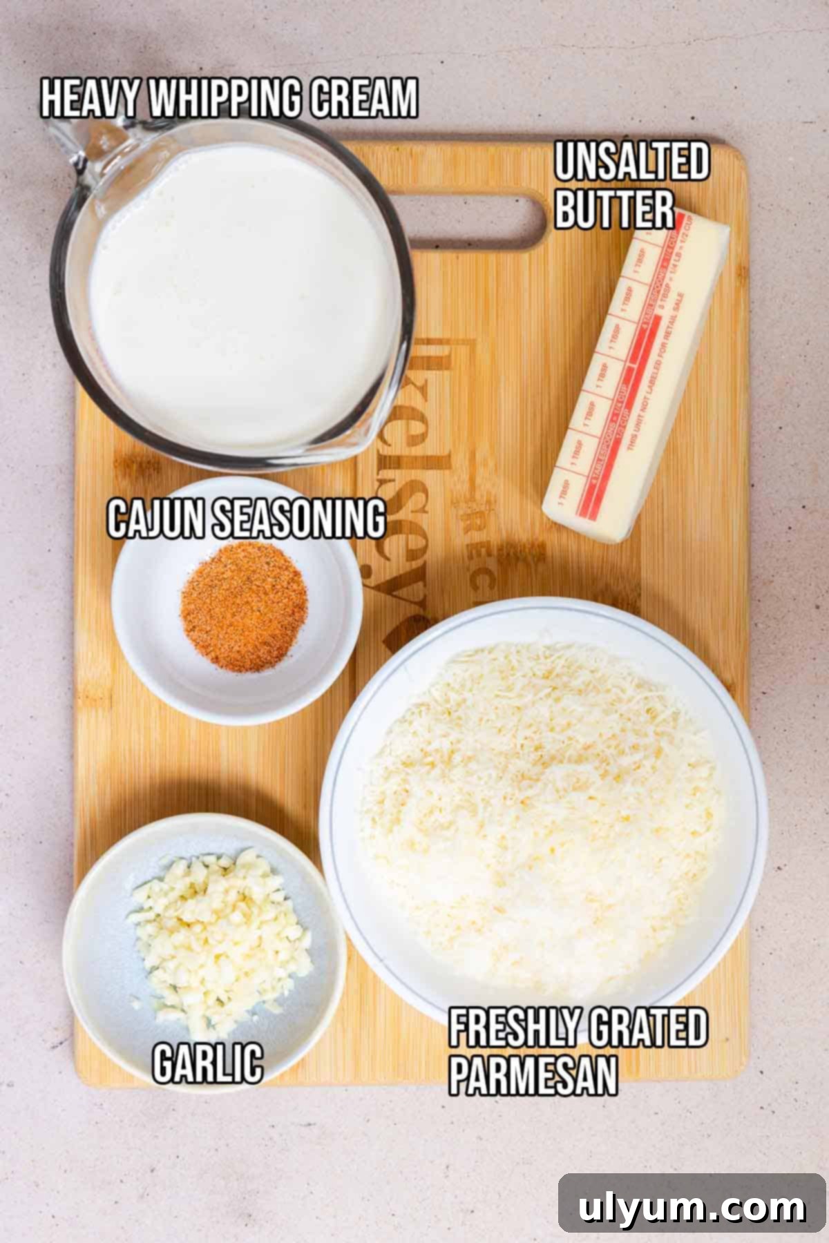 Cajun Alfredo sauce ingredients: butter, garlic, parmesan, and cajun seasoning.