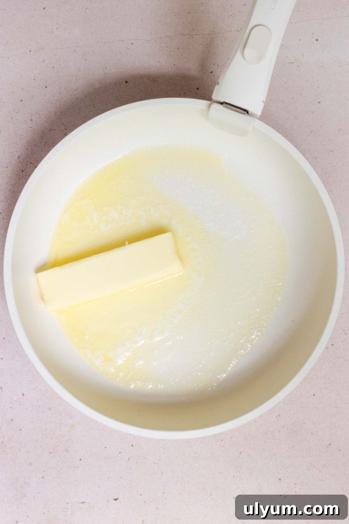 Butter melting in a large skillet.