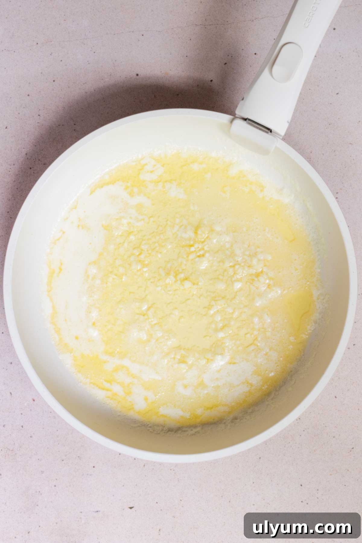 Garlic sautéing in butter in a large skillet.