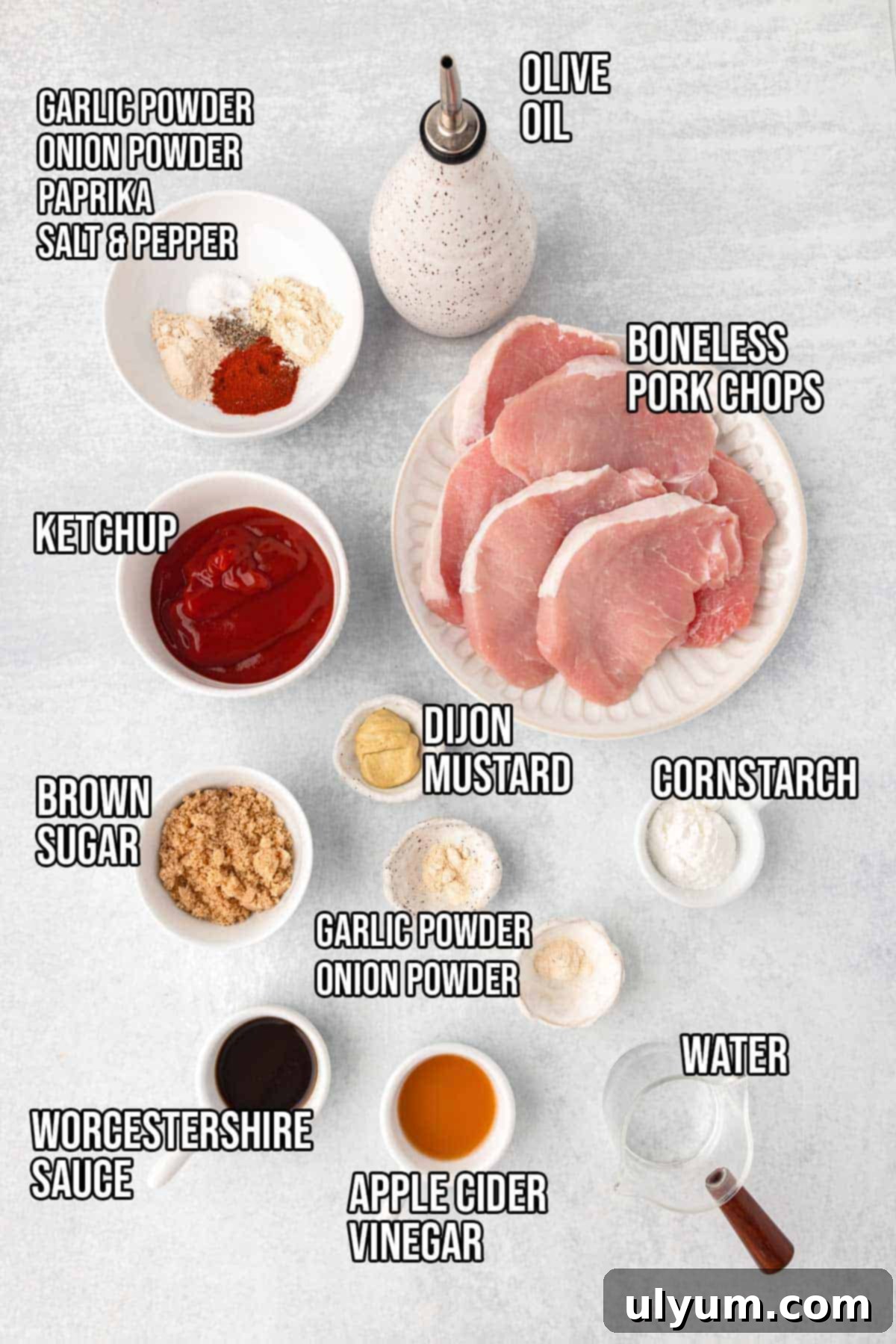 Boneless pork chops, garlic powder, onion powder, paprika, salt, pepper, olive oil, ketchup, brown sugar, apple cider vinegar, Worcestershire sauce, and Dijon mustard.