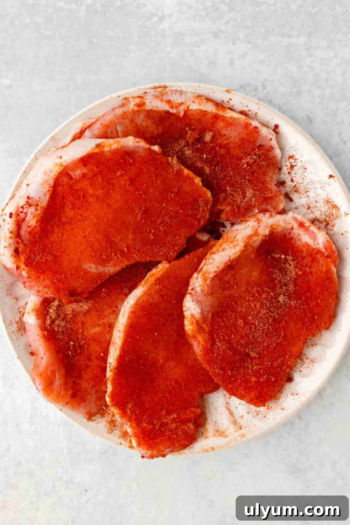 Boneless pork chops are covered in a BBQ dry rub.