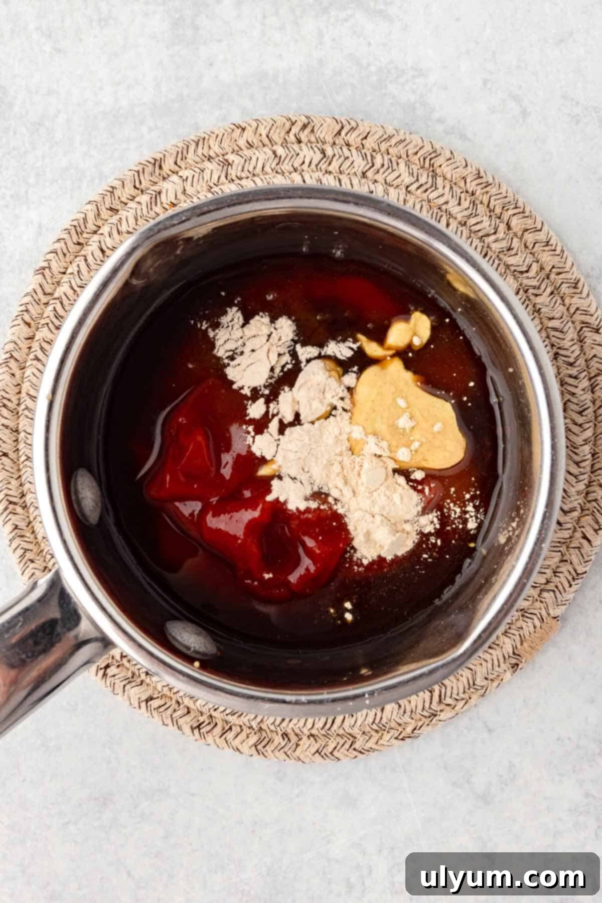 Ketchup, brown sugar, apple cider vinegar, Worcestershire sauce, Dijon mustard, garlic powder, and onion powder are added to a small saucepan.