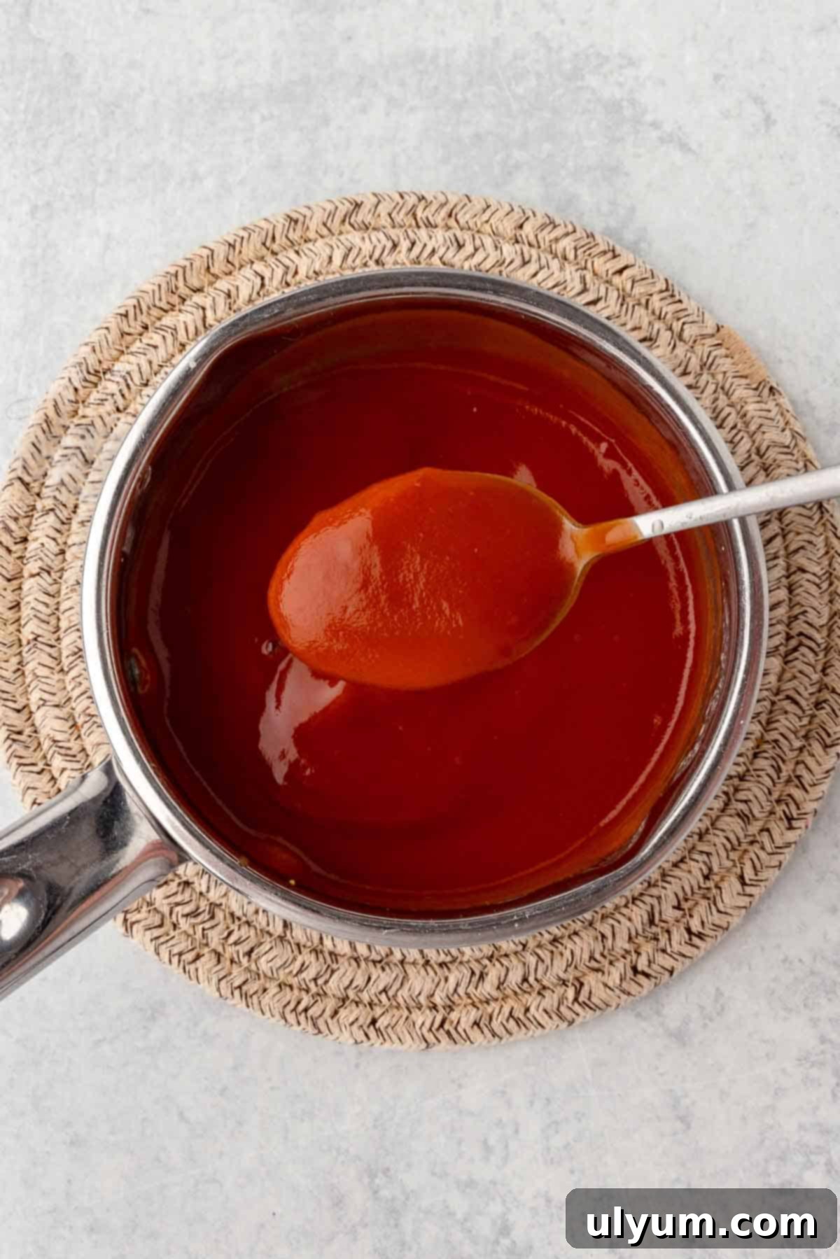 The BBQ sauce is cooked in a small saucepan until thickened.