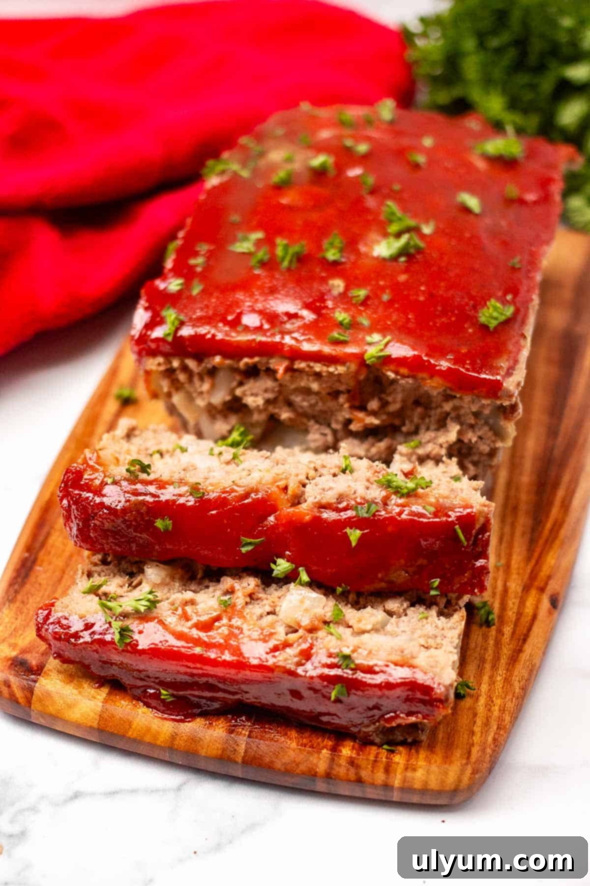 Meatloaf topped with a ketchup glaze and sliced into serving size portions.