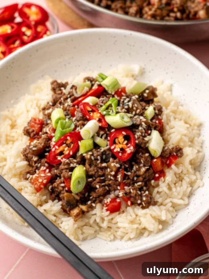 Sweet Chili Ground Beef Bowls served with rice and topped with sesame seeds.