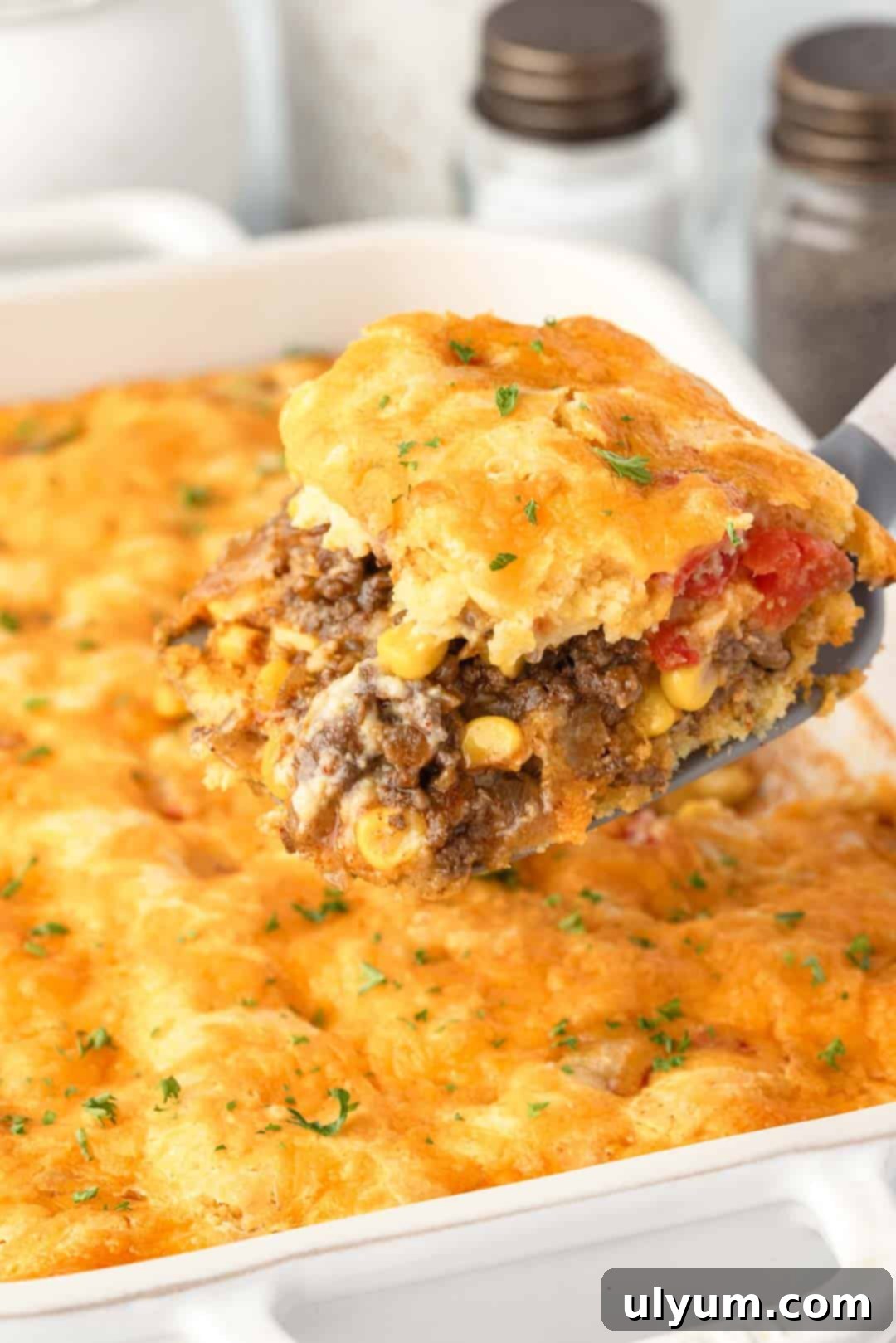 Ground Beef Jiffy Cornbread Casserole served from a 9 by 13 inch baking dish, ready to eat.
