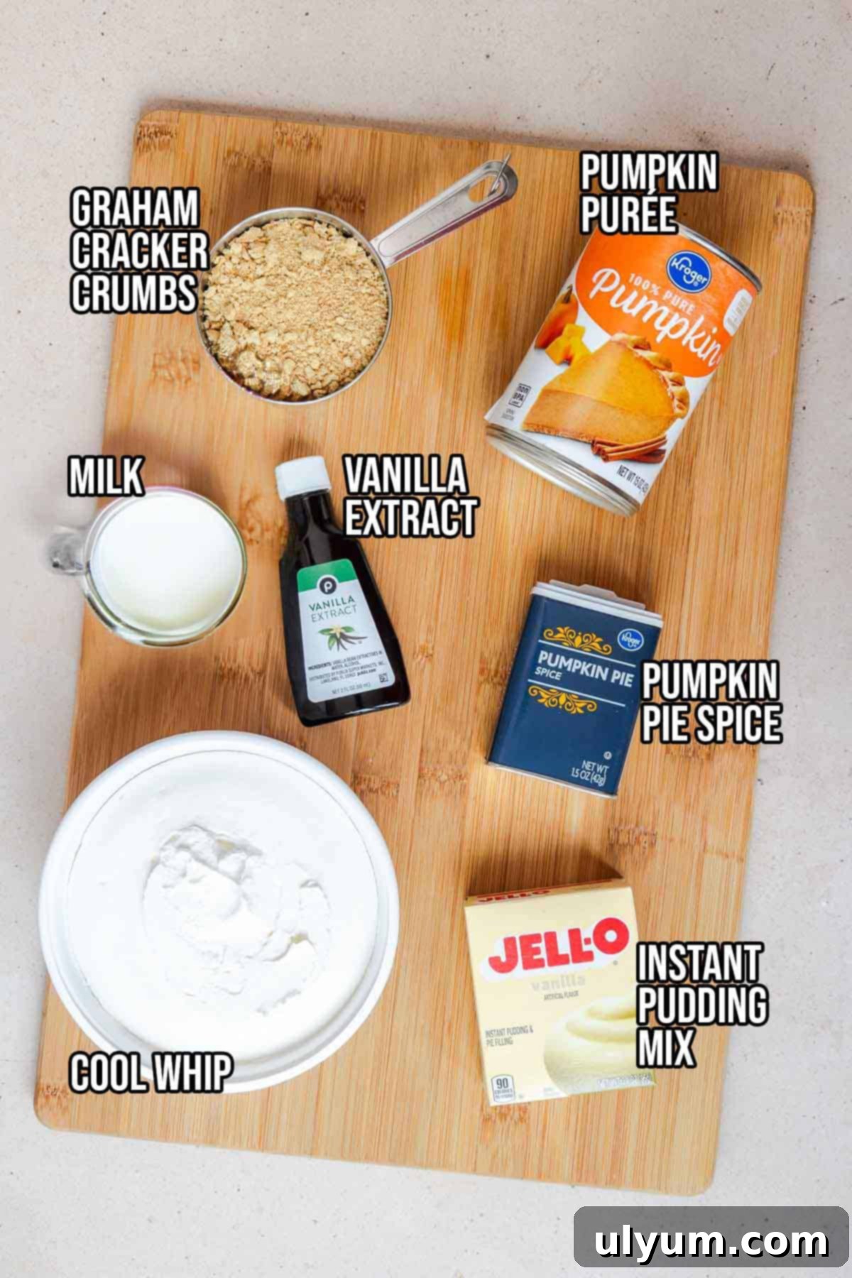 Pumpkin pie cup ingredients: canned pumpkin purée, milk, instant vanilla pudding mix, pumpkin pie spice, vanilla extract, Cool Whip, graham cracker and graham cracker crumbs.