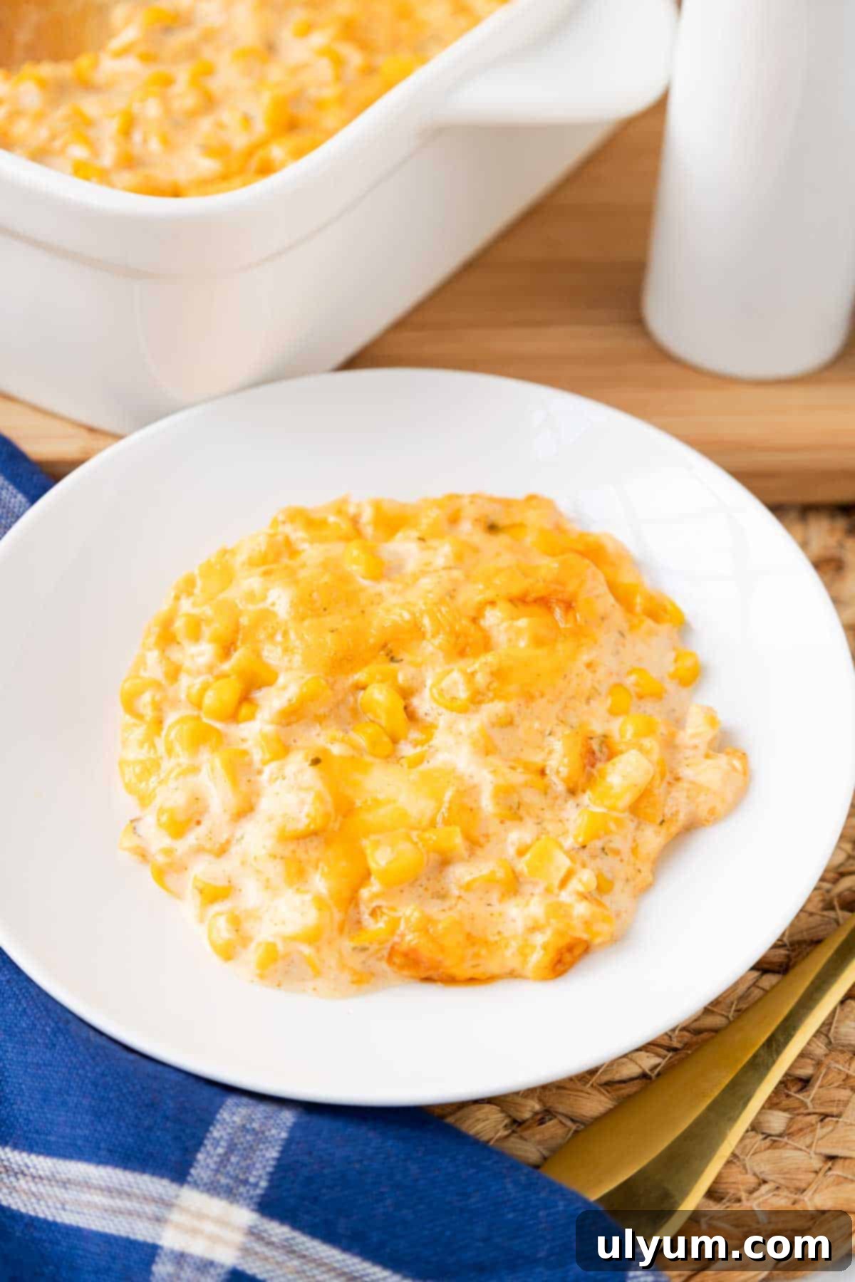 Cheesy Velveeta corn casserole plated on a small side dish.