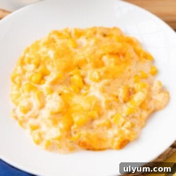 Cheesy corn casserole plated on a small side dish.