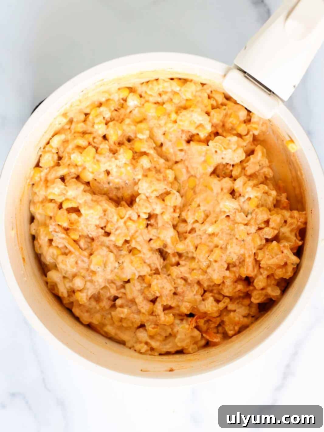 Cheesy corn casserole mixture in a medium saucepan.