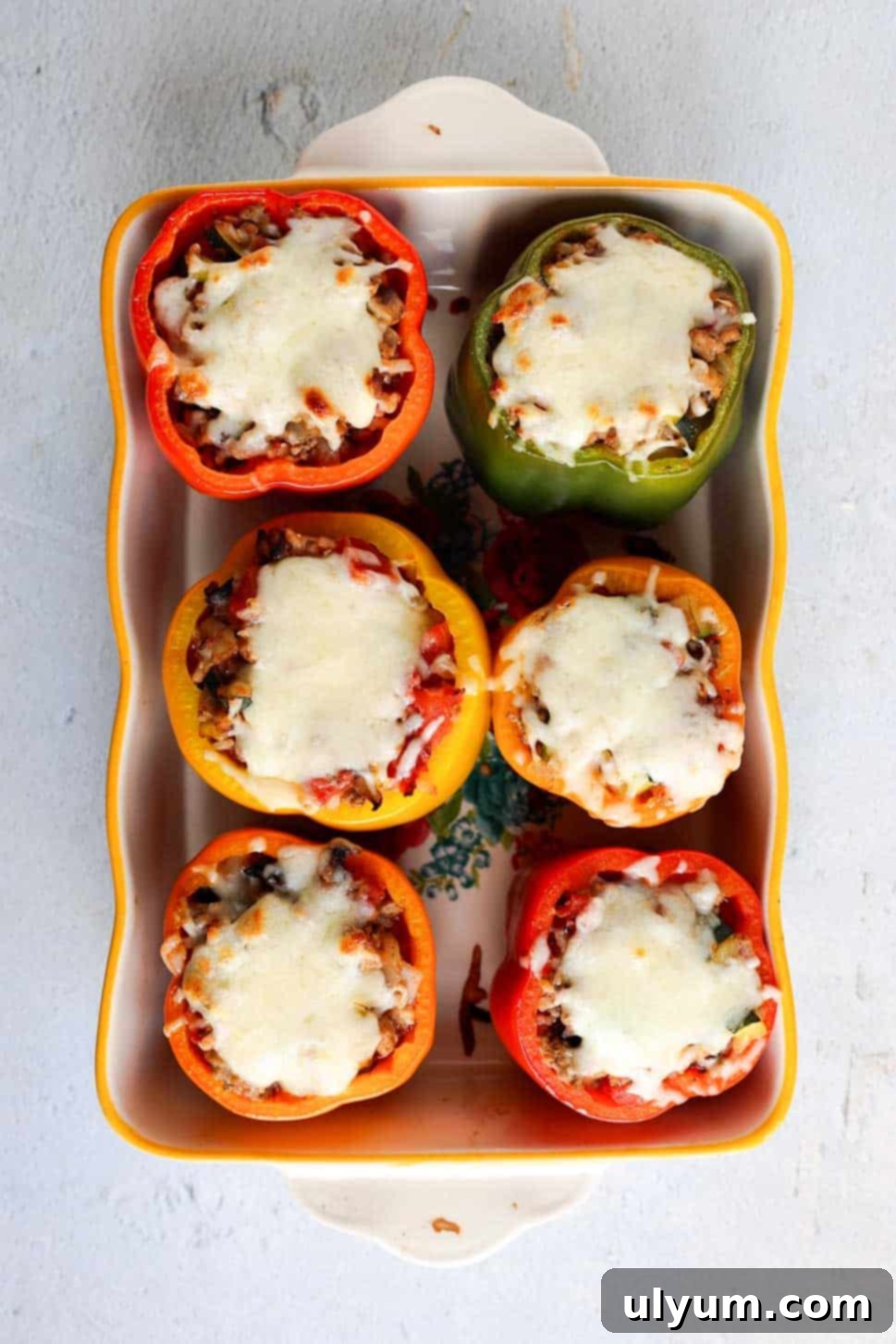 Hearty Ground Turkey and Rice Stuffed Peppers 11 Baking dish filled with six beautifully baked, whole stuffed bell peppers, each generously topped with gloriously melted mozzarella cheese, ready to be served.
