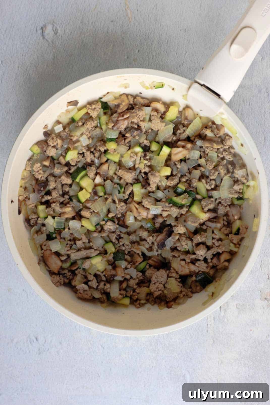 Hearty Ground Turkey and Rice Stuffed Peppers 6 Diced zucchini and mushrooms are added to the browned ground turkey and onion mixture in the skillet, cooking down until tender and releasing their moisture, creating a rich base for the stuffing.