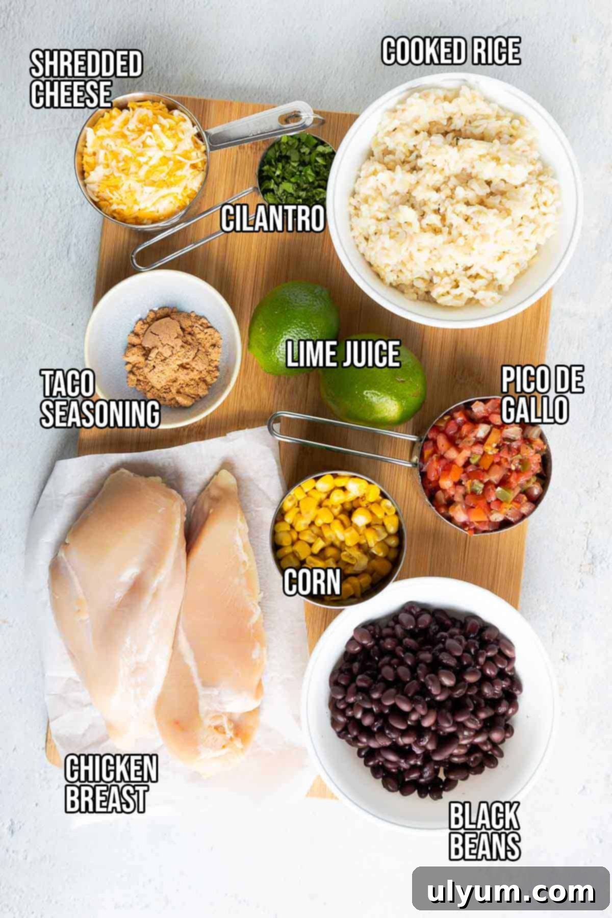 Southwest chicken bowl ingredients: chicken breast, taco seasoning, cooked rice, fresh cilantro, lime, black beans, corn, pico de gallo, and shredded Mexican blend cheese.