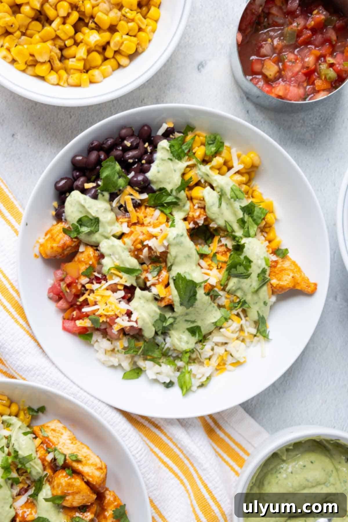 Southwest chicken rice bowls with pico de gallo, cilantro lime rice, black beans, corn, cheese, and avocado dressing