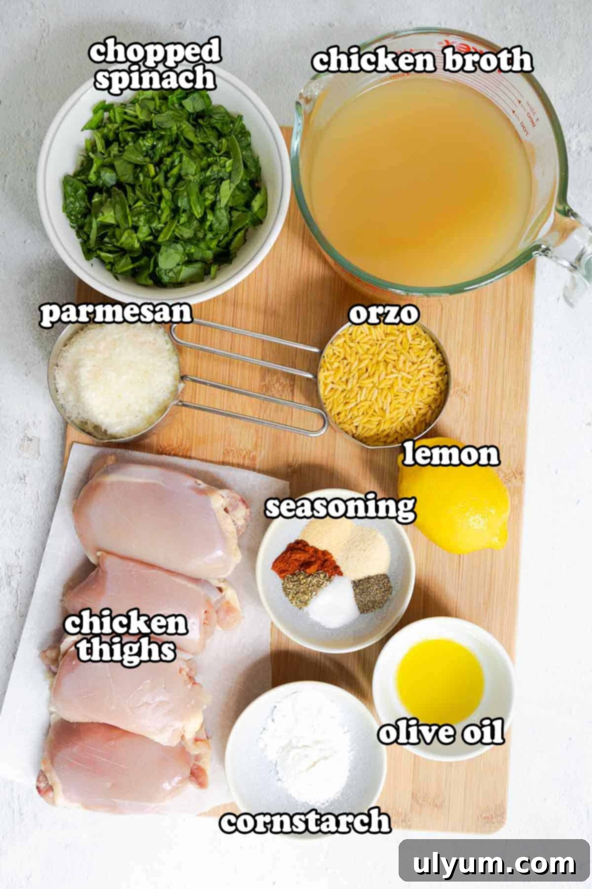 Bright Lemon Chicken Orzo Skillet 3 Ingredients for lemon chicken orzo: chicke thighs, cornstarch, olive oil, seasonings, lemon, uncooked orzo, parmesan, chopped spinach, and chicken broth.