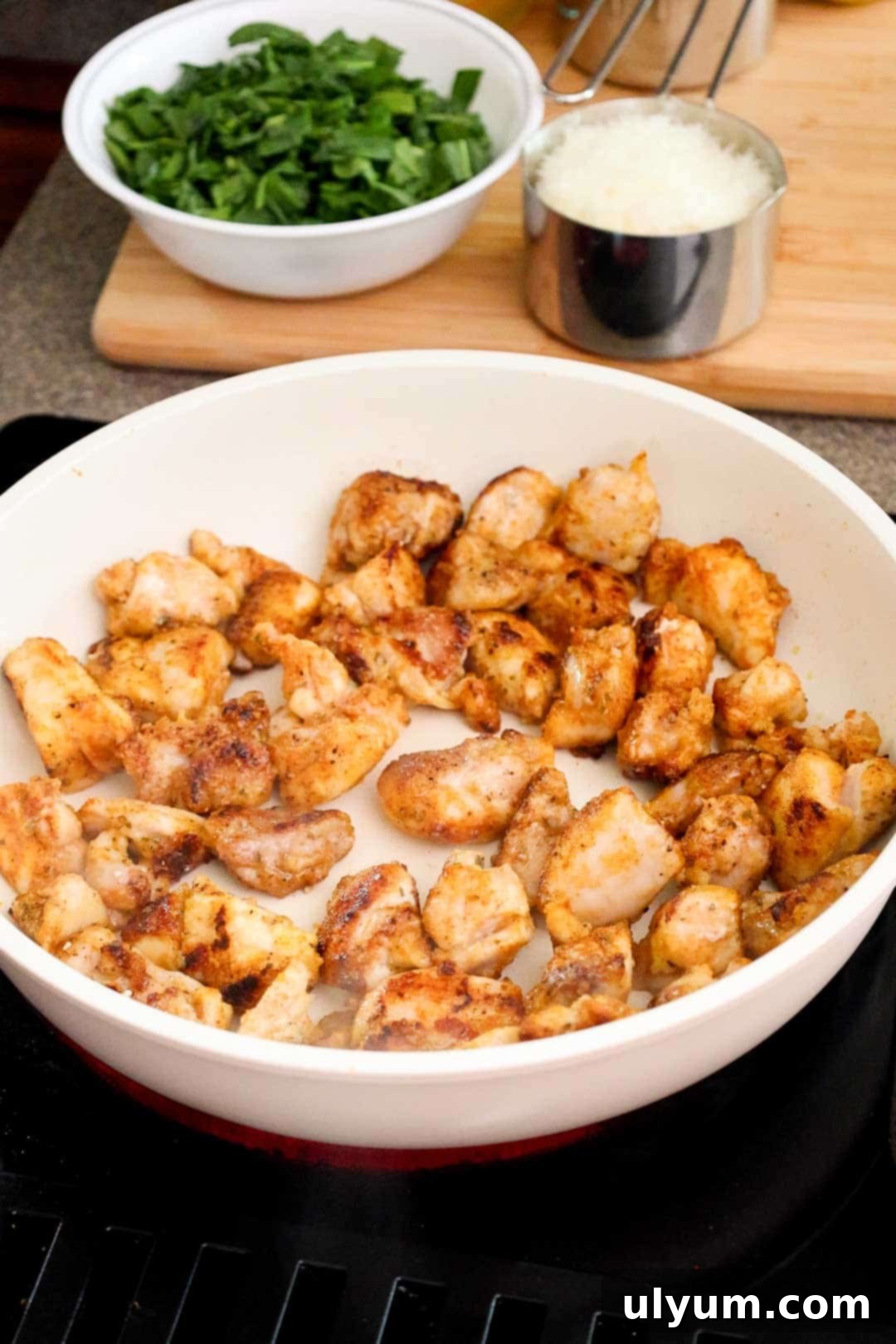 Bright Lemon Chicken Orzo Skillet 5 Cooked diced chicken thighs in a large skillet.