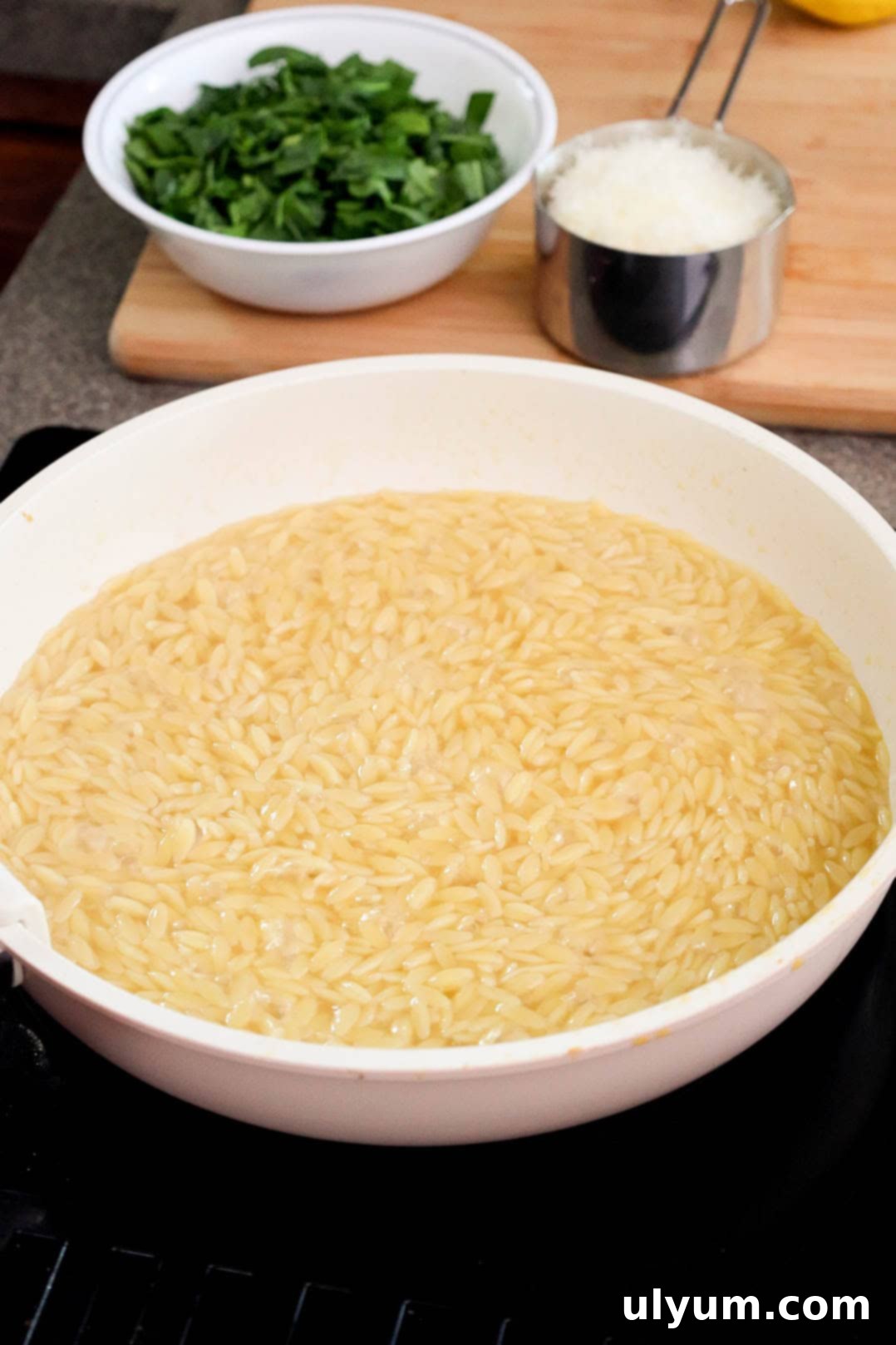 Bright Lemon Chicken Orzo Skillet 6 Cooked orzo in a large skillet with some liquid leftover.
